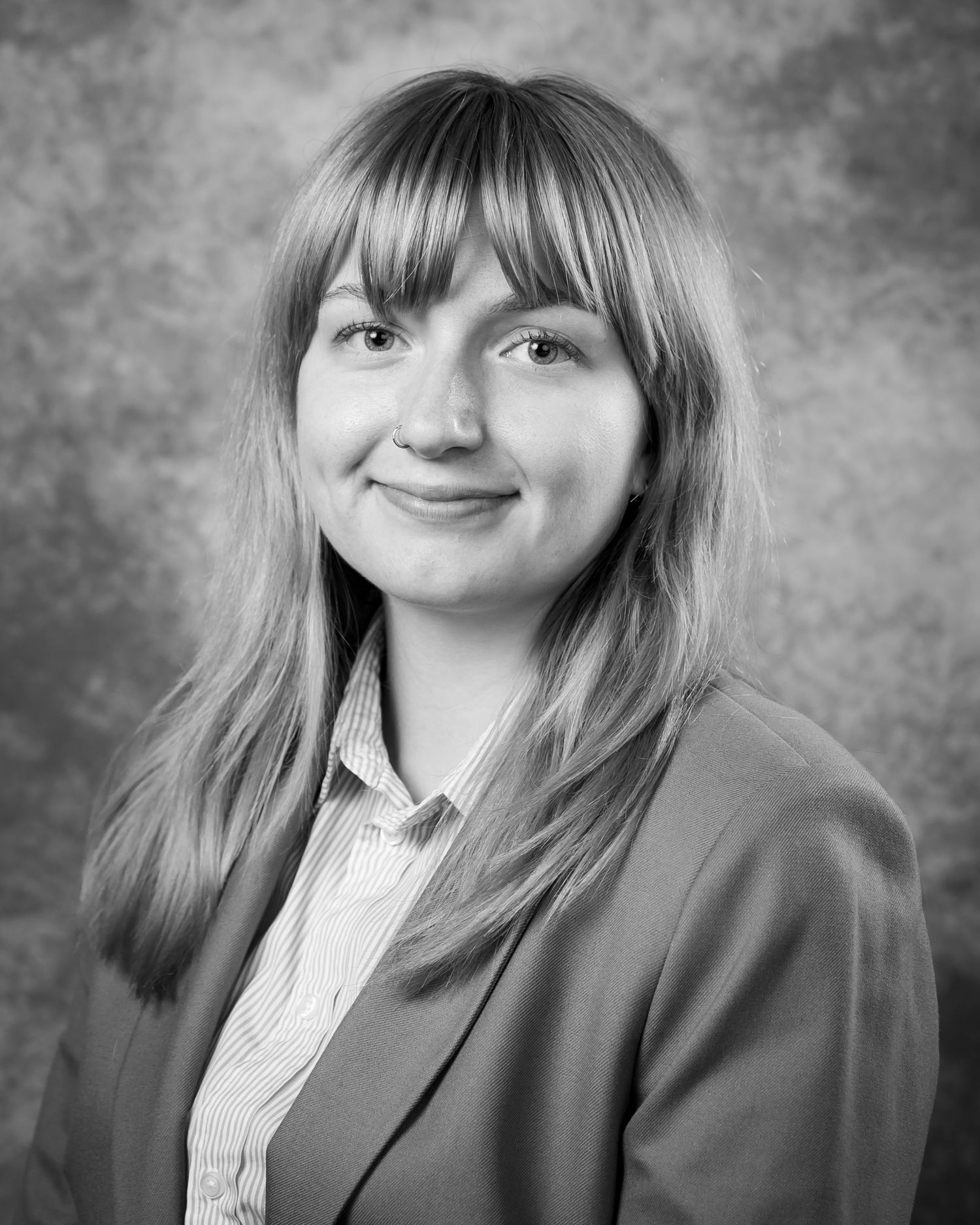 A series of black and white portraits showing a person in business attire expressing different playful expressions.