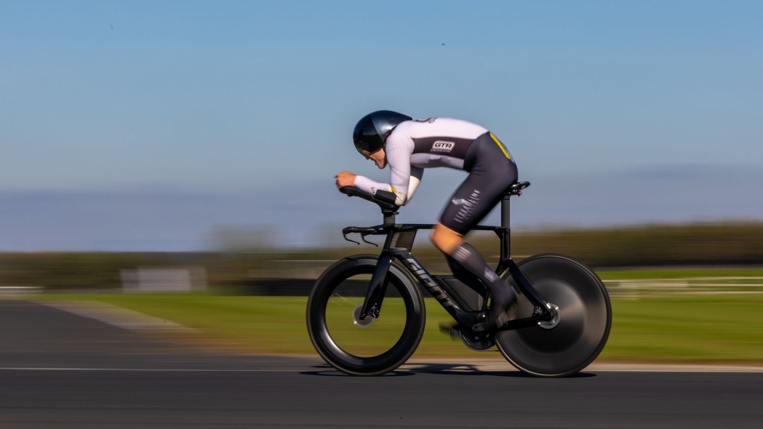 A sequence of cycling images showing a cyclist in an aerodynamic position racing on a time trial bike.