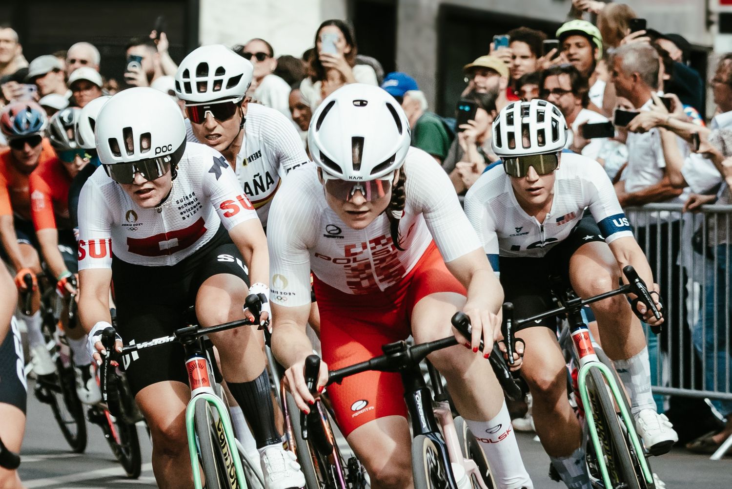 Cyclists racing in tight pack during competitive road race.