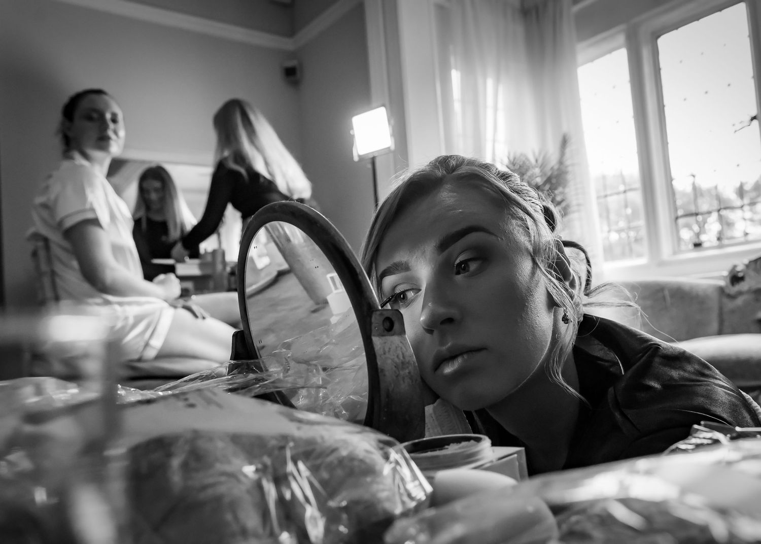Black and white photo sequence shows people working intensely at desks in an office setting.