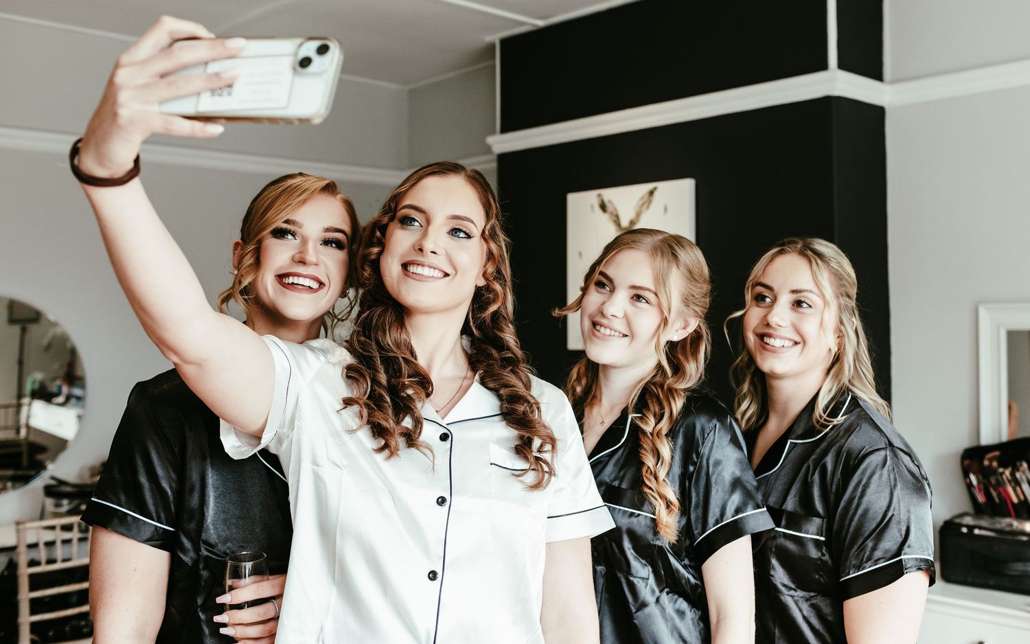 People celebrating together in an office space with drinks and smiles during a casual gathering.