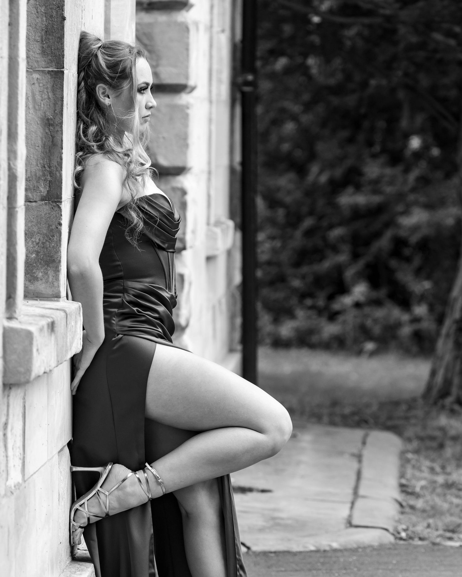Black and white artistic dance portrait showing graceful poses against a classic architectural backdrop.