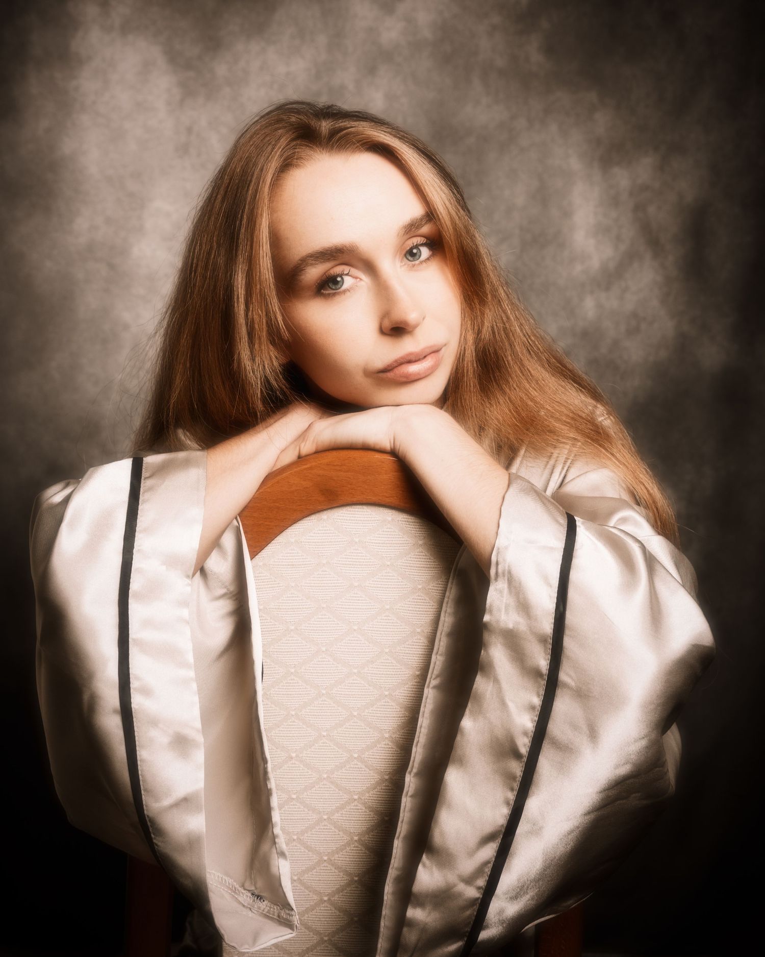 A series of artistic portrait photographs showing a figure in soft lighting against a dark textured background.