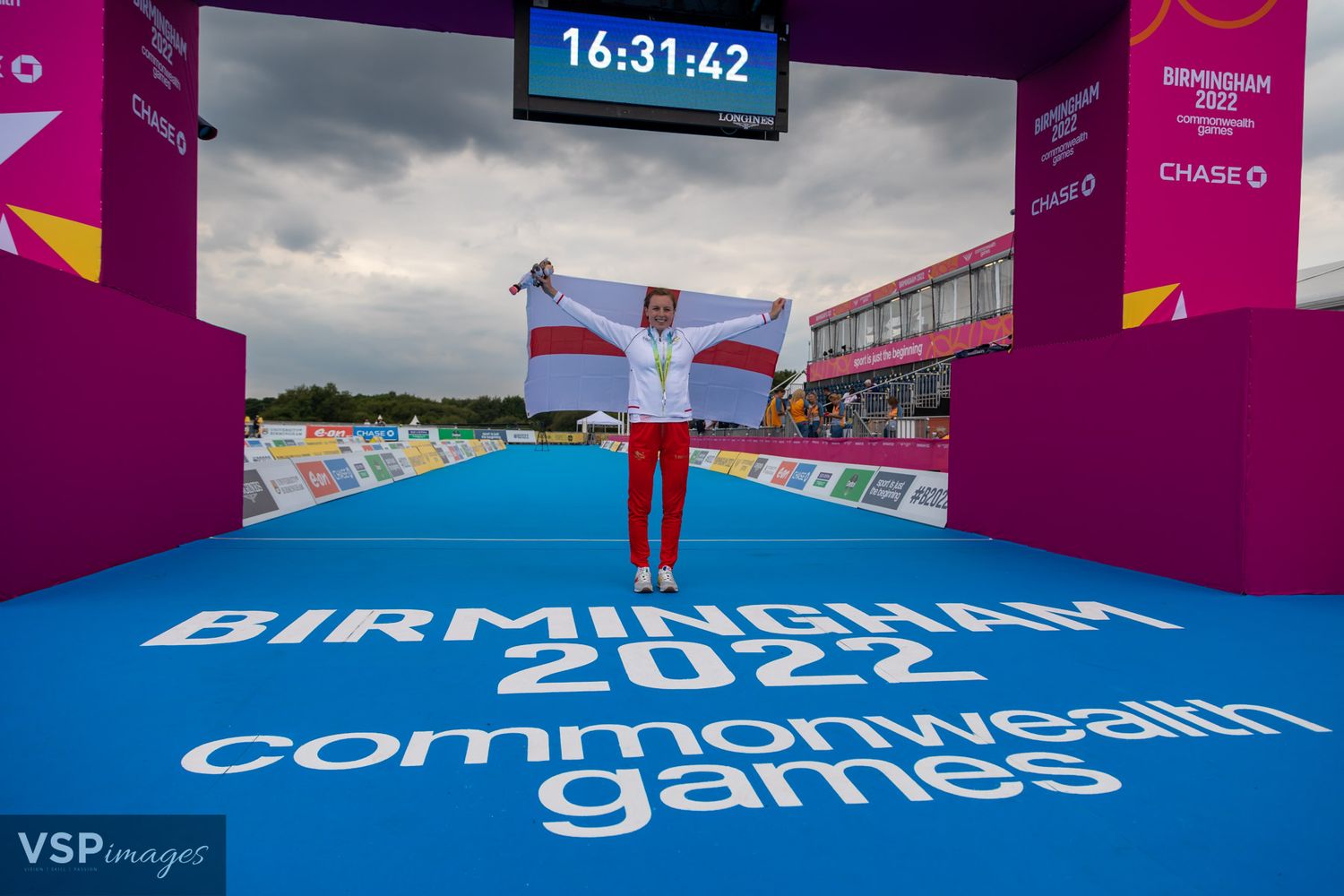 Purple and blue branded event space setup for Commonwealth Games competition.