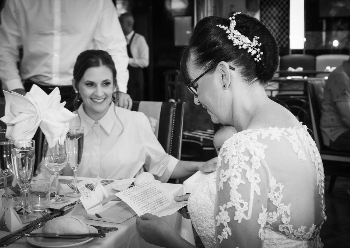 Wedding reception candid moments captured in black and white photography.