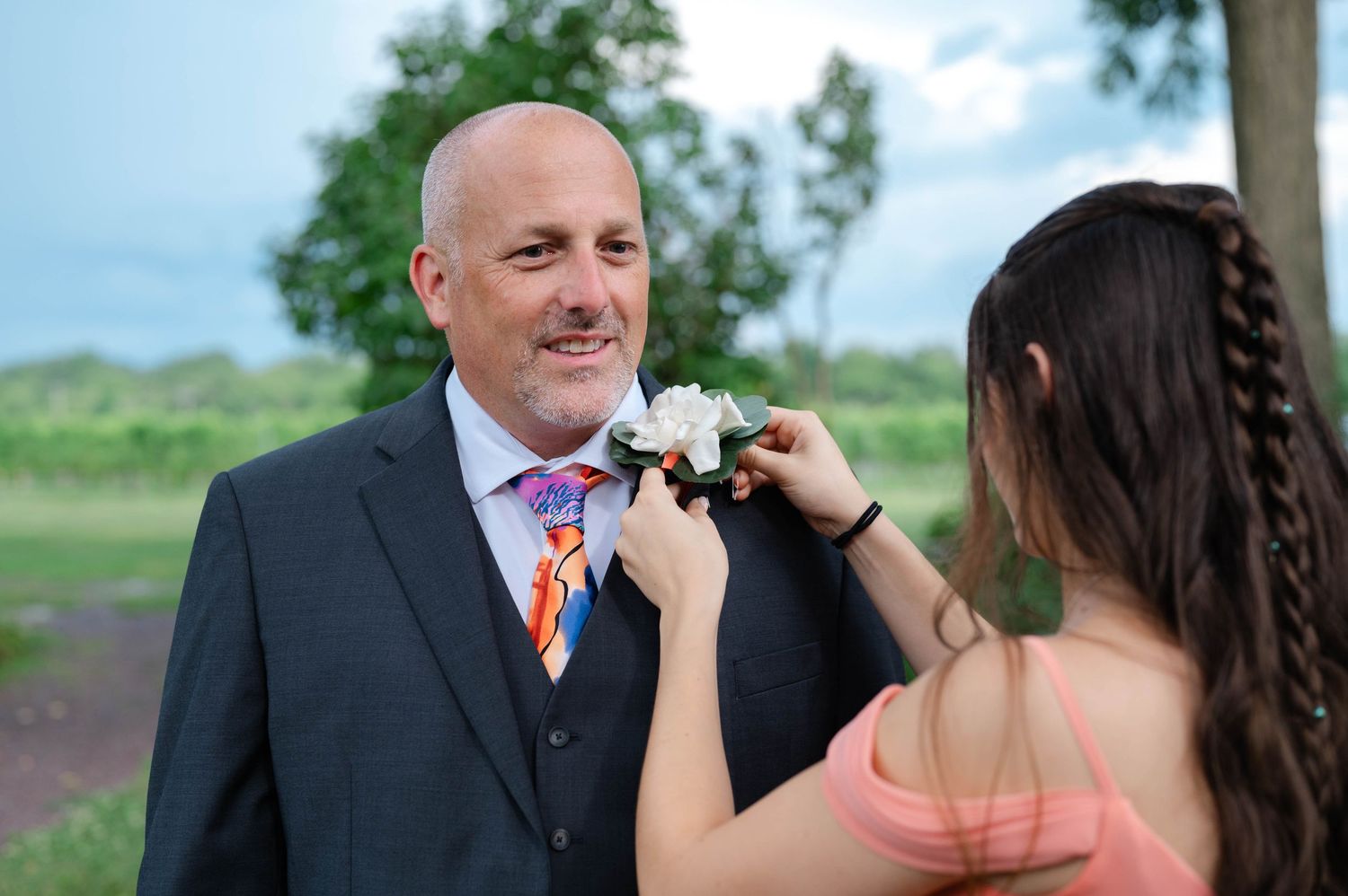 Grooms daughter helping with boutonnière