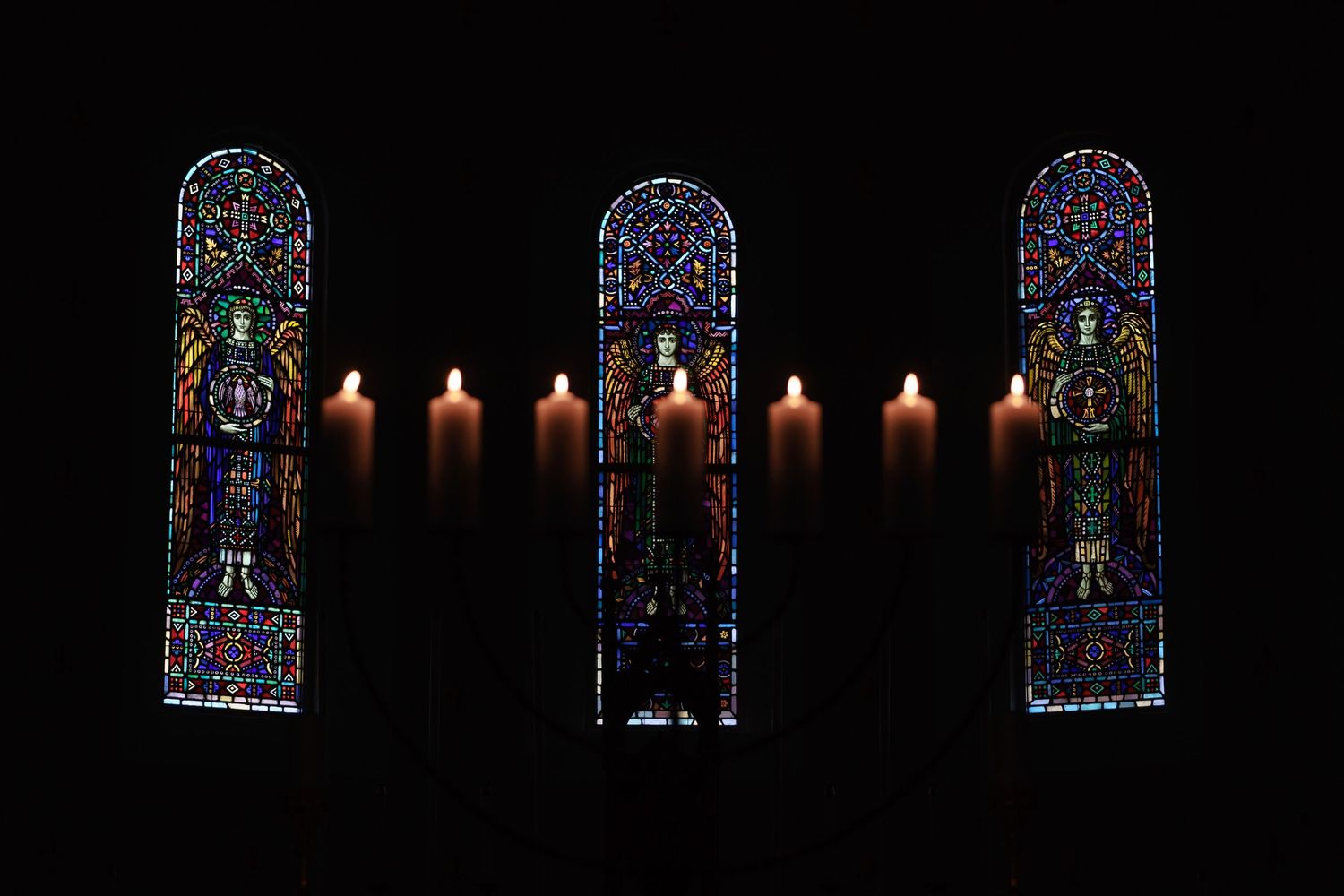 Candles in front of stained glass