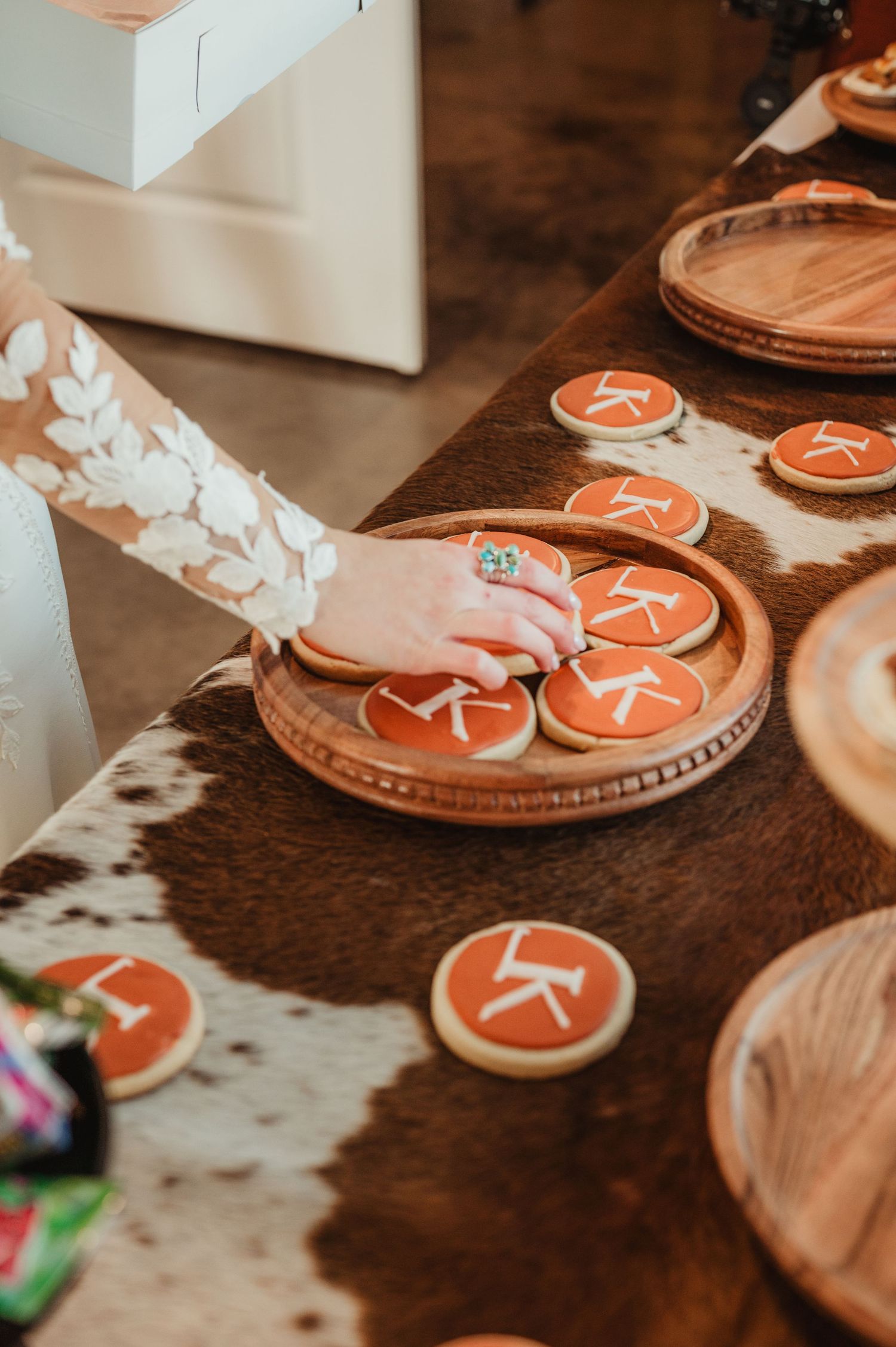 Orange-colored star-shaped cookies displayed on rustic wooden surfaces.