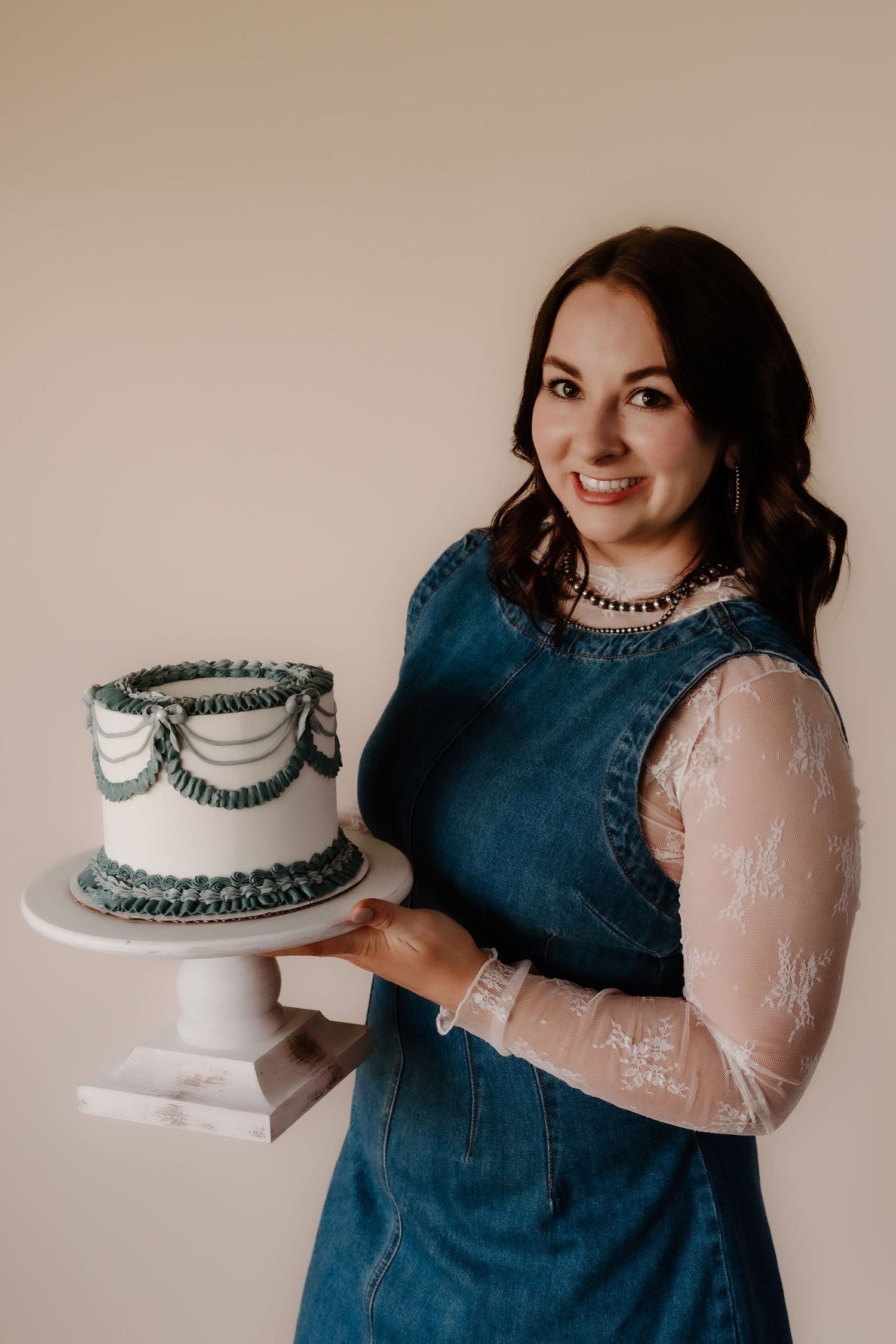 A series of elegant poses showcasing a white and gray decorated cake.