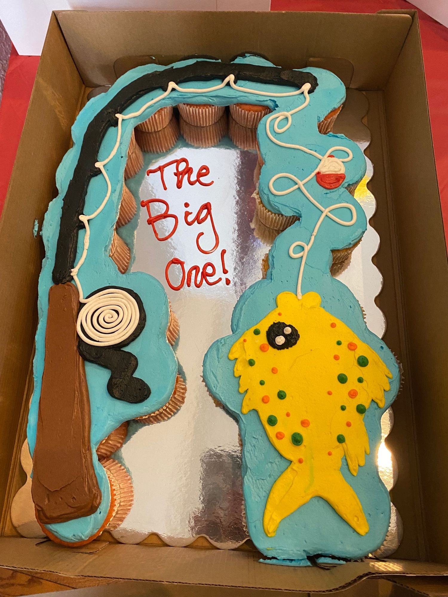 A sea-themed cake with teal waves and a yellow starfish design.