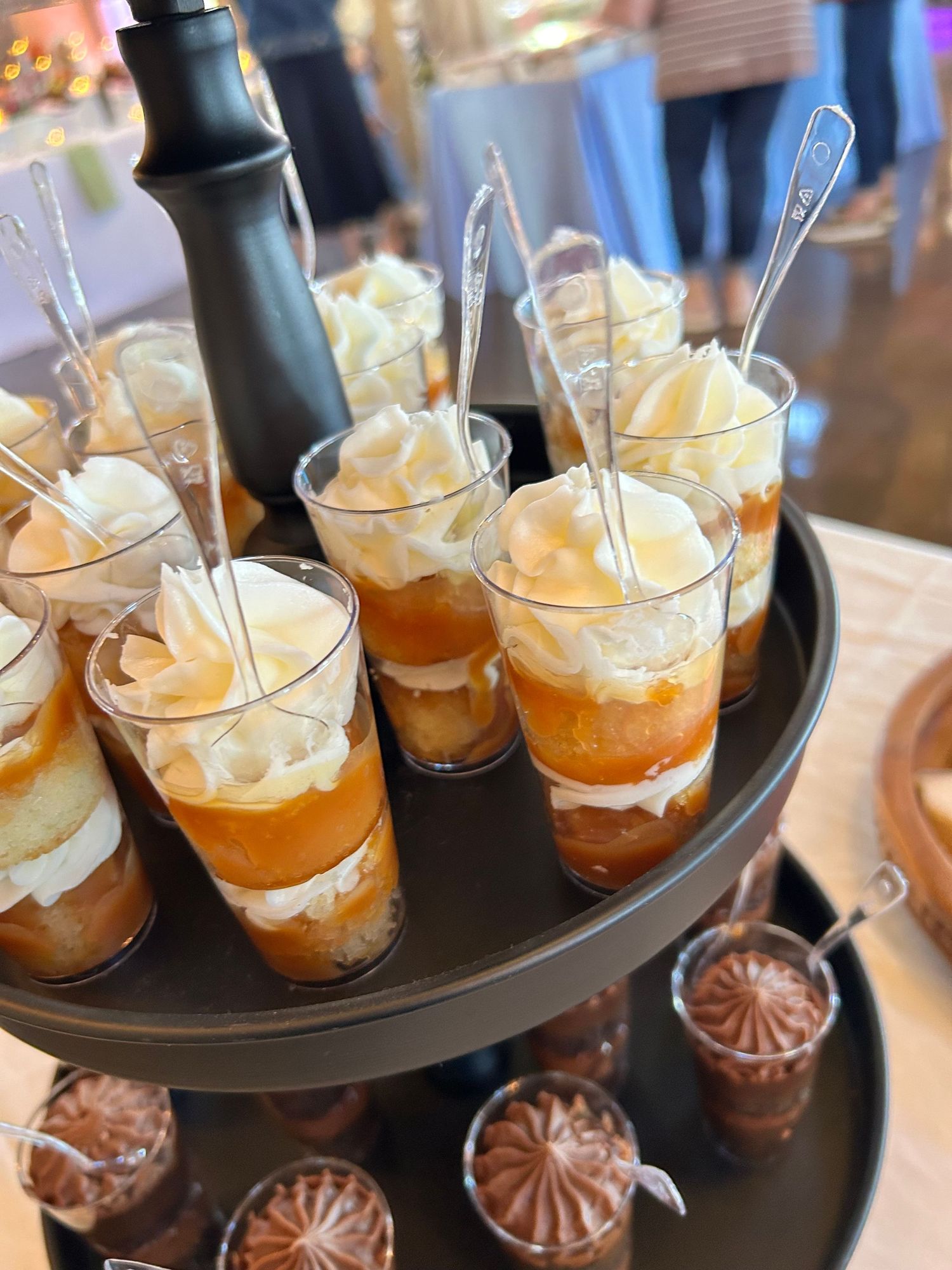 Dessert shooters with layered cream and caramel served in small glass cups.