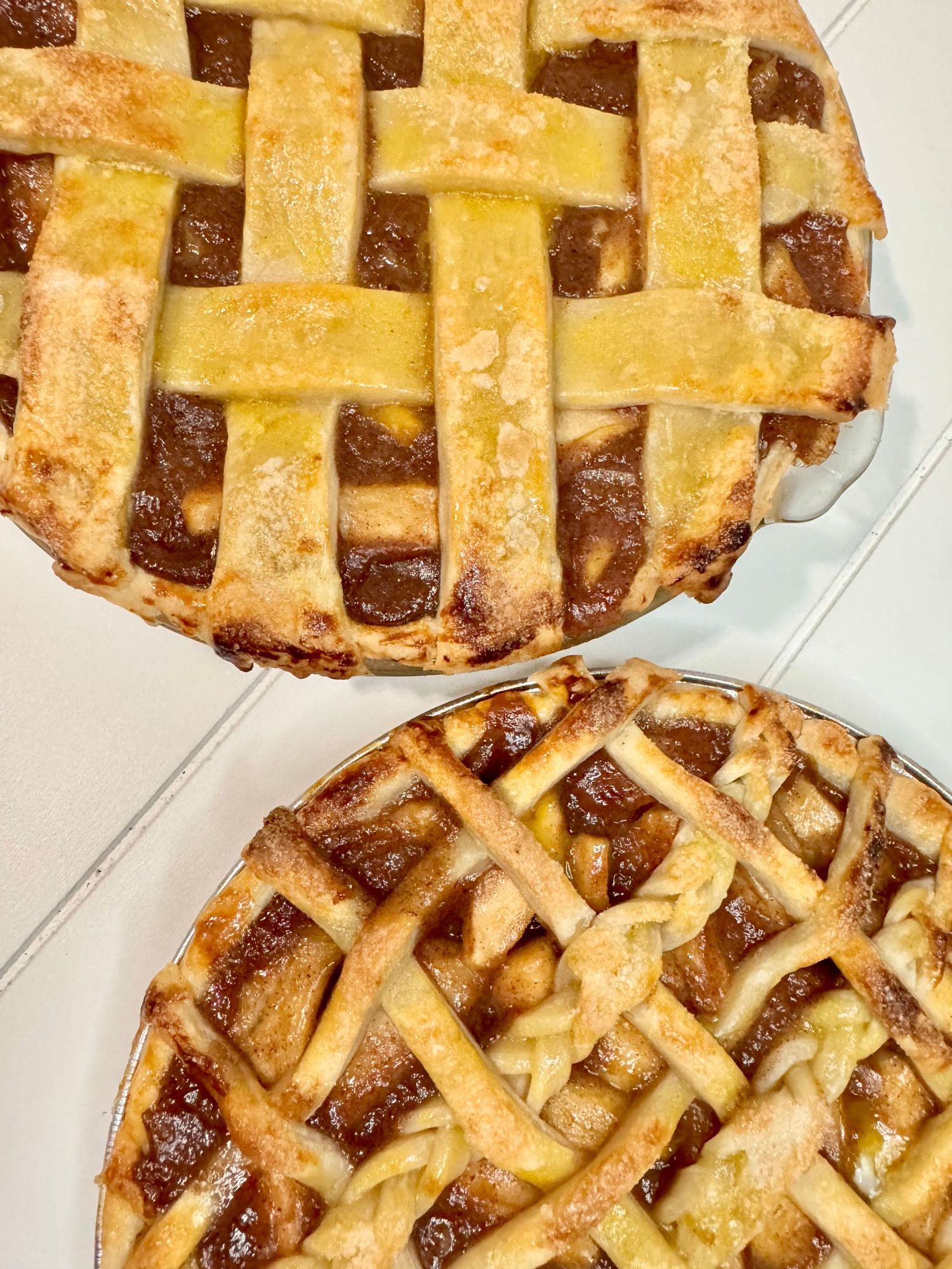 Homemade lattice apple pie with golden brown crust and visible fruit filling.
