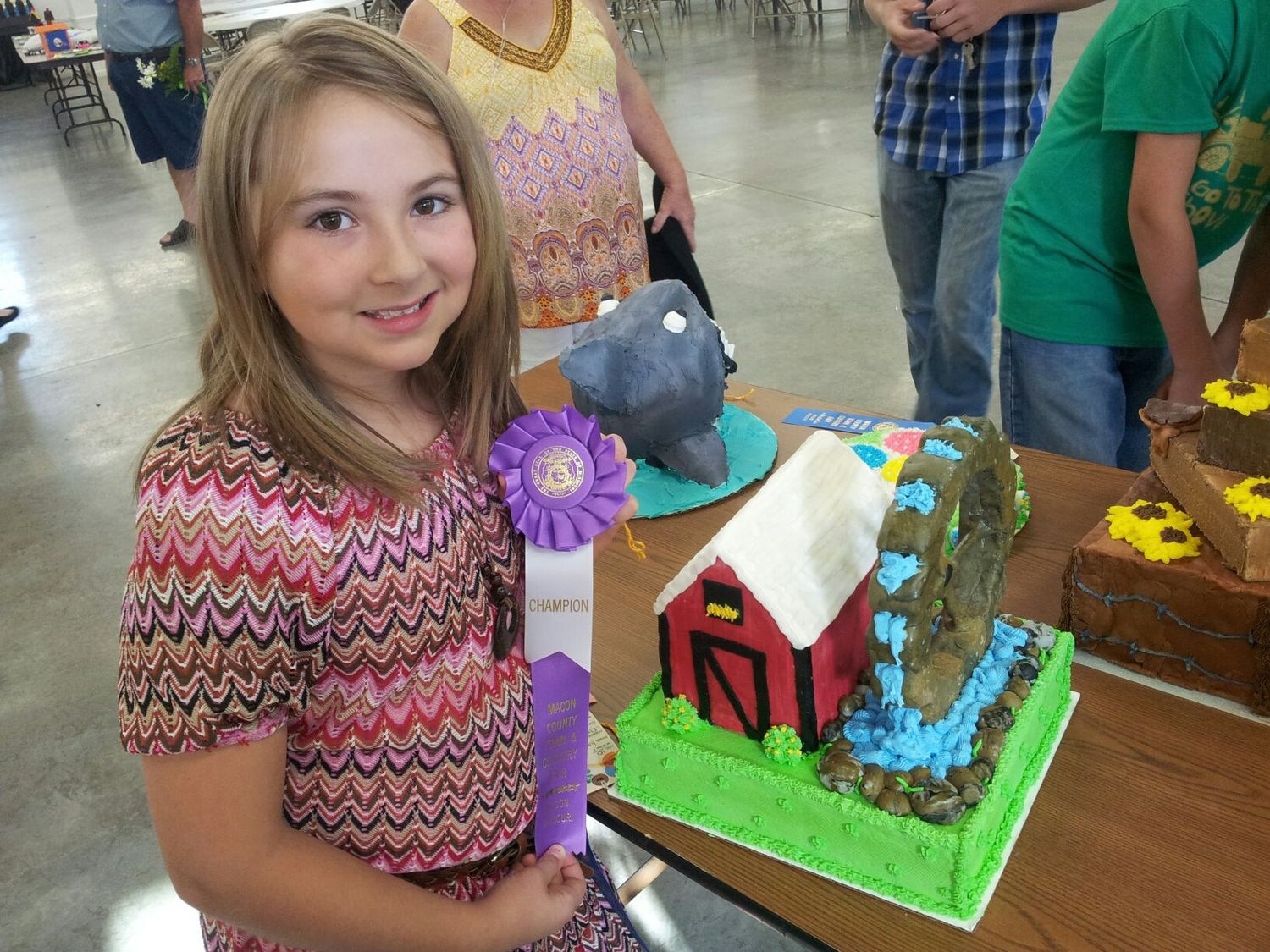 Students gather around a colorful cake decorating activity at a classroom table during a creative workshop.