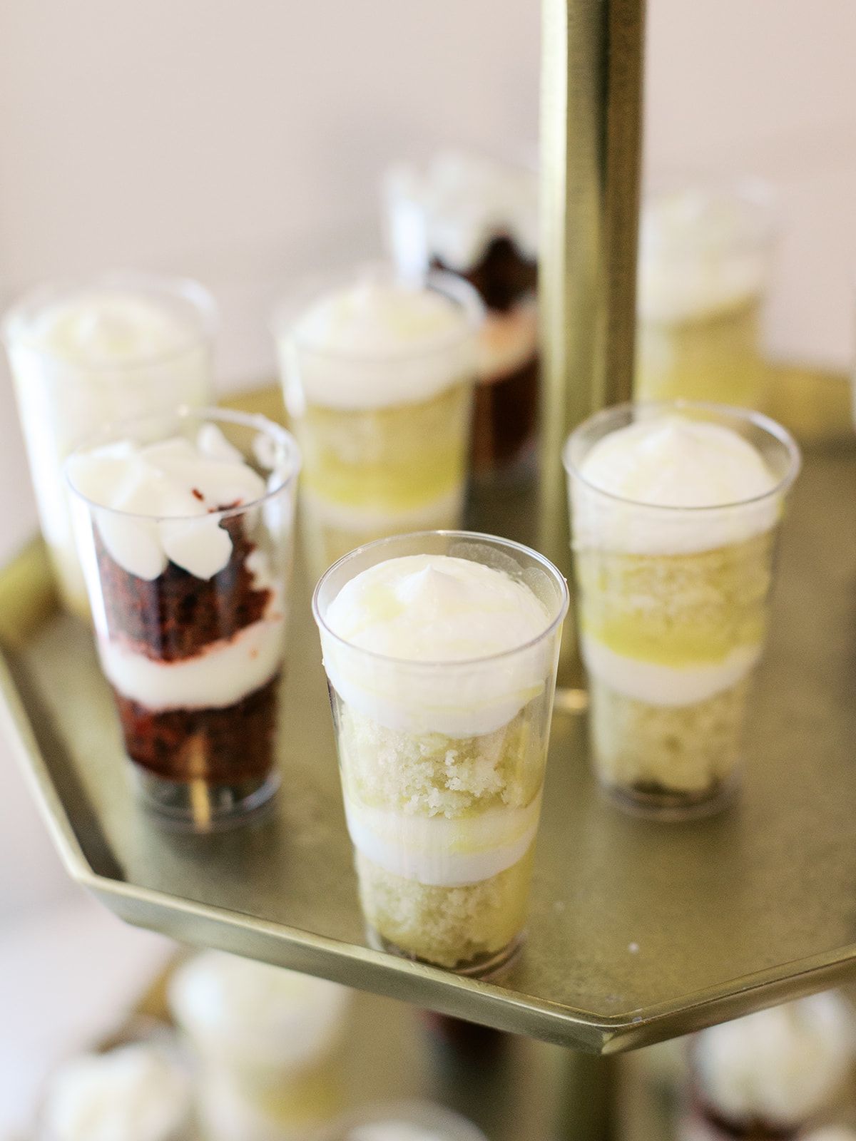 Individual dessert parfaits in glass cups with layered cream and chocolate.