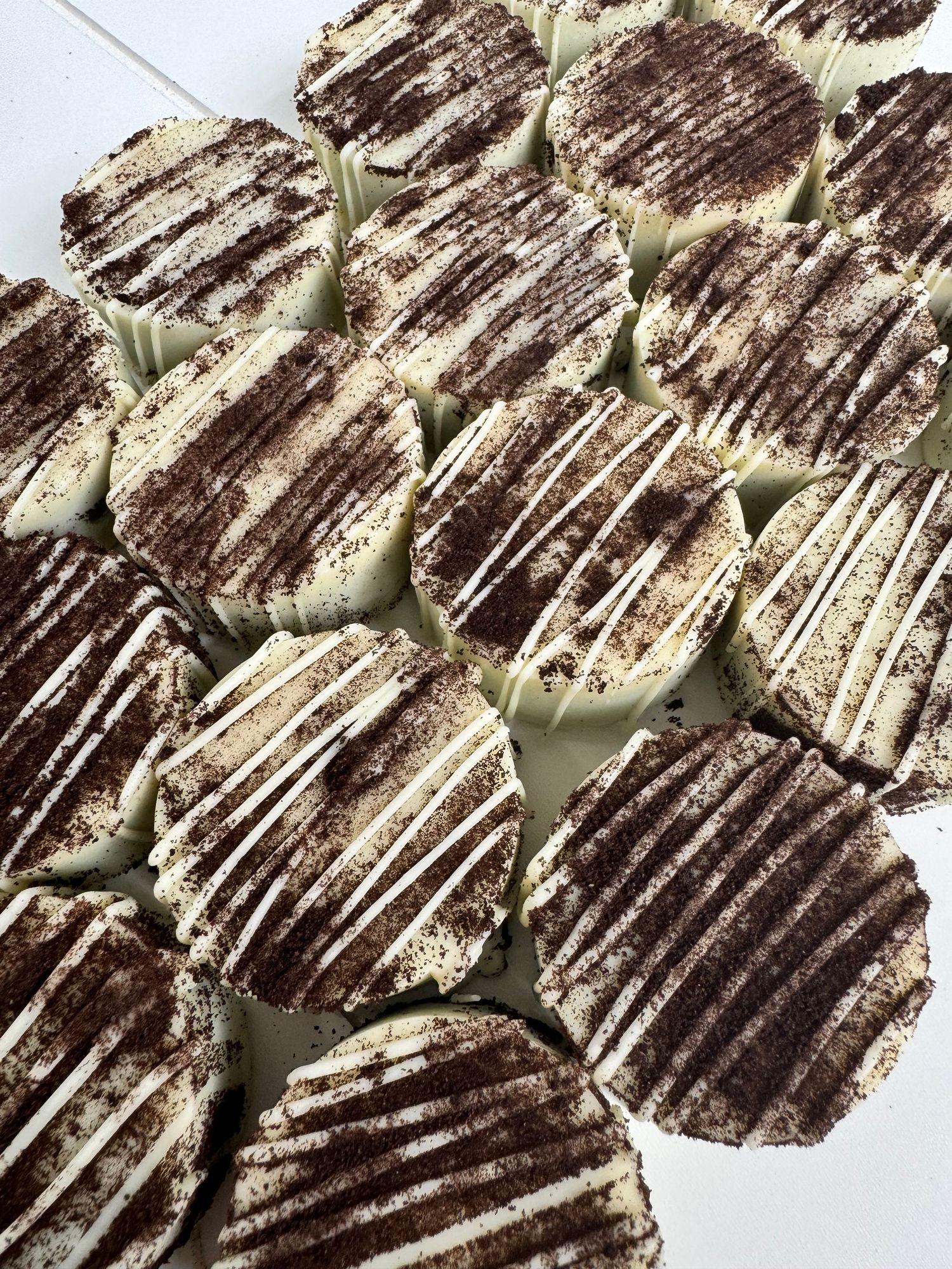Dark chocolate bark drizzled with white chocolate in a decorative pattern.