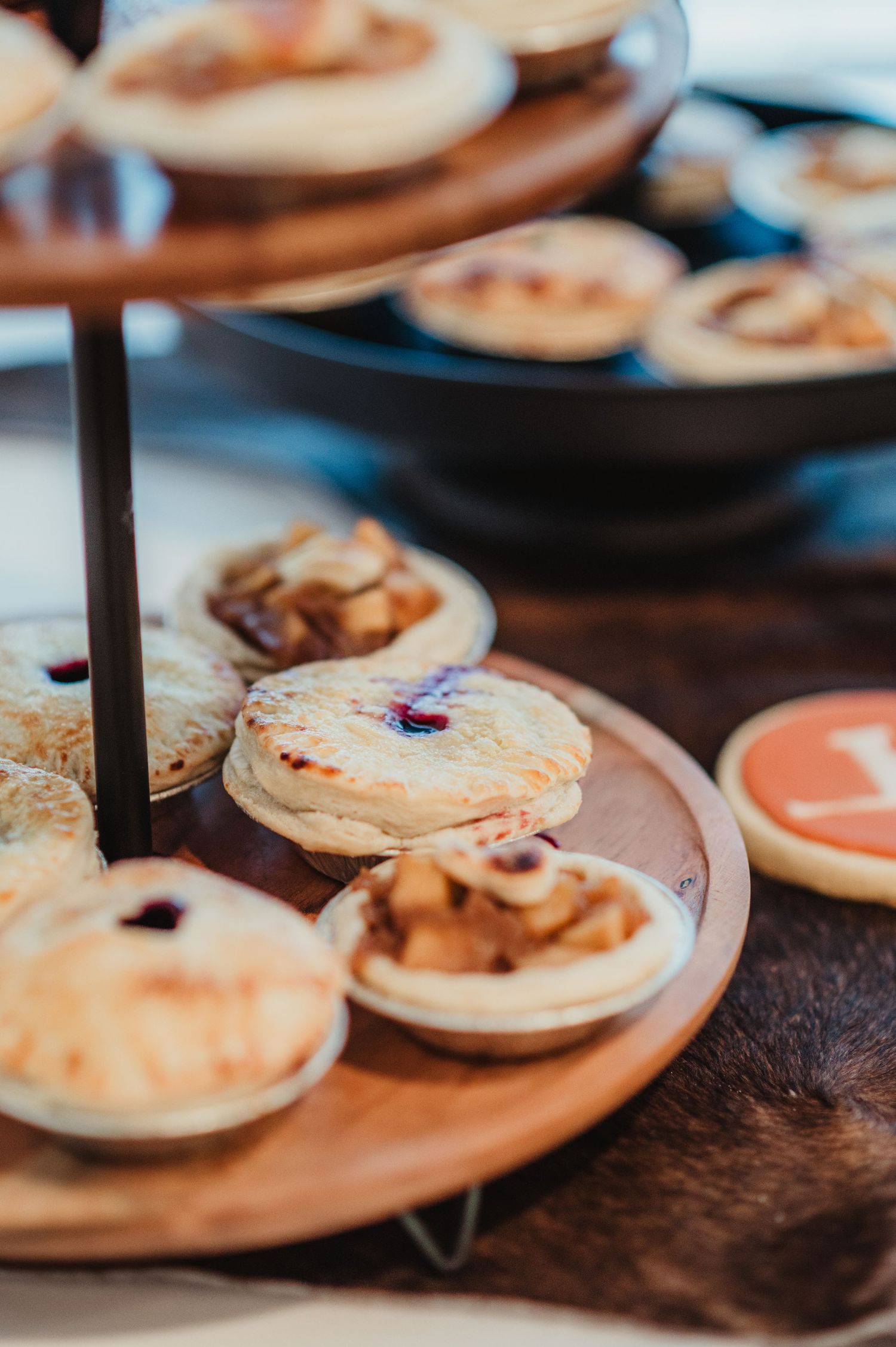 Artisanal macarons arranged on wooden serving boards.