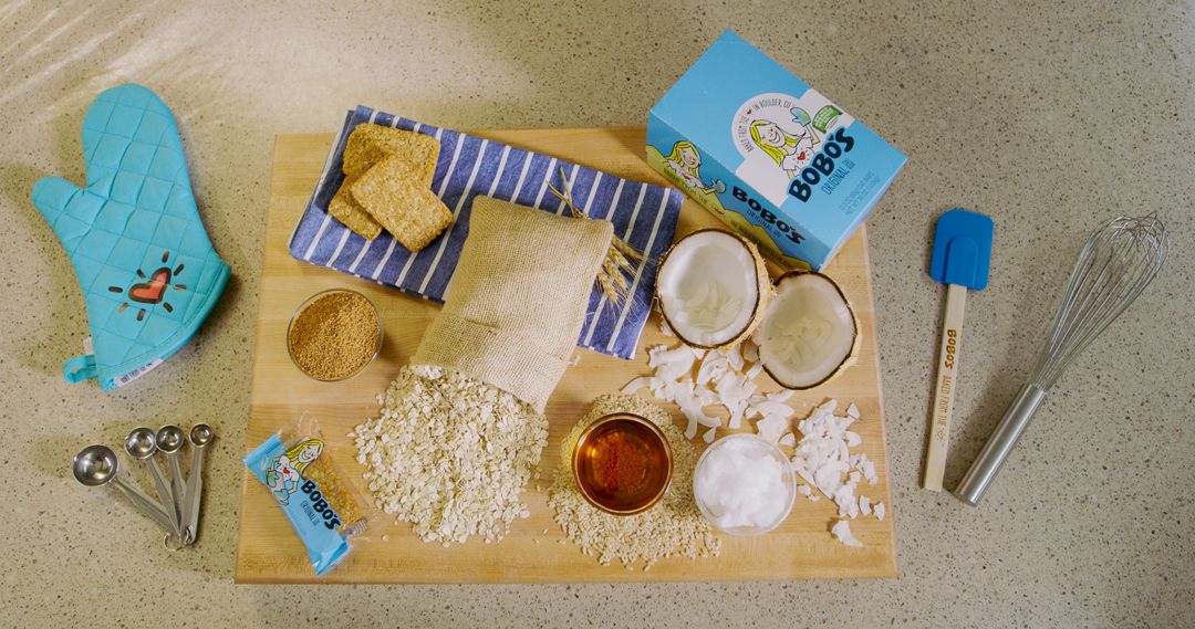 Cooking ingredients and spices spread out on a wooden cutting board.