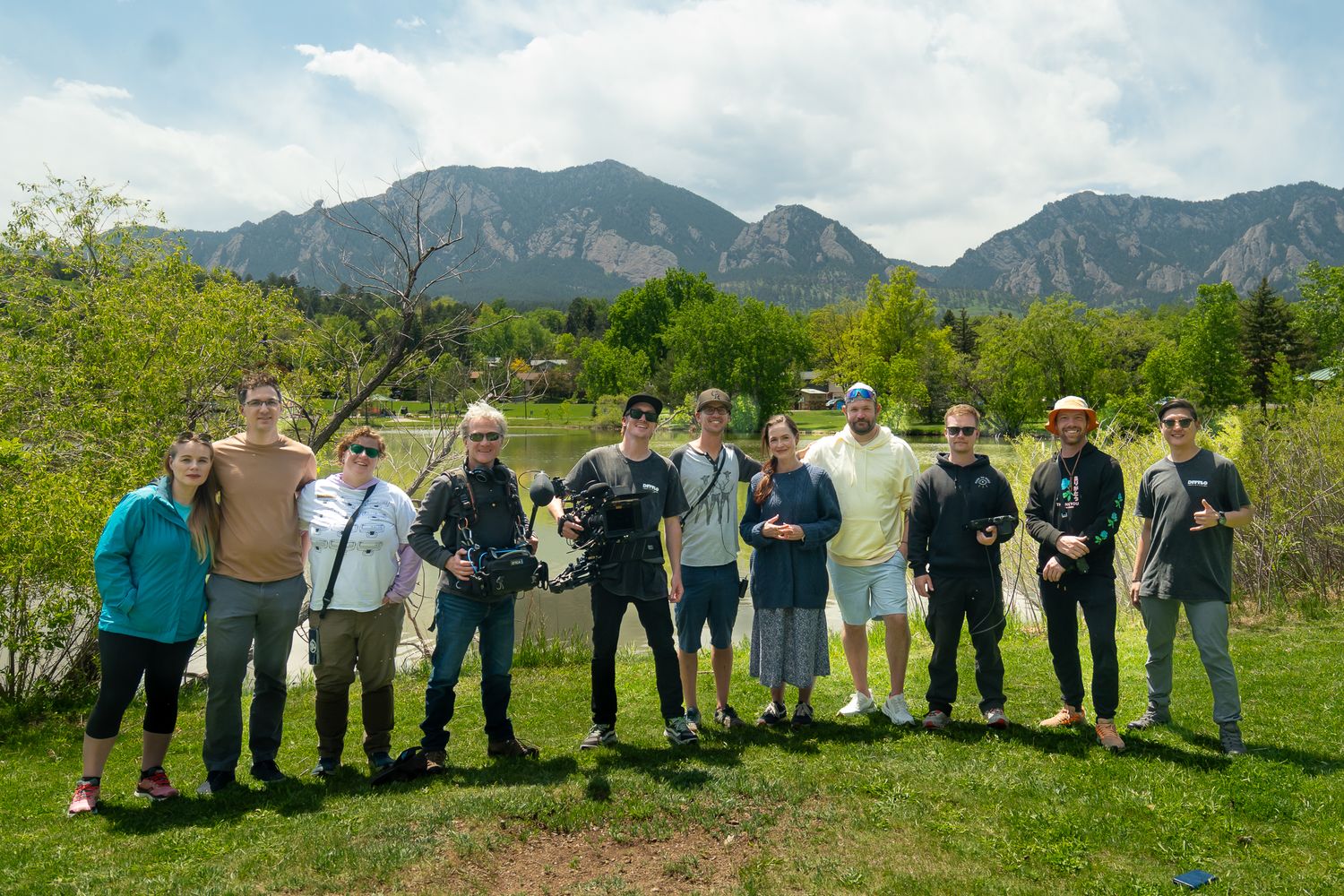 A panoramic sequence of people lined up against a mountain backdrop in Colorado.