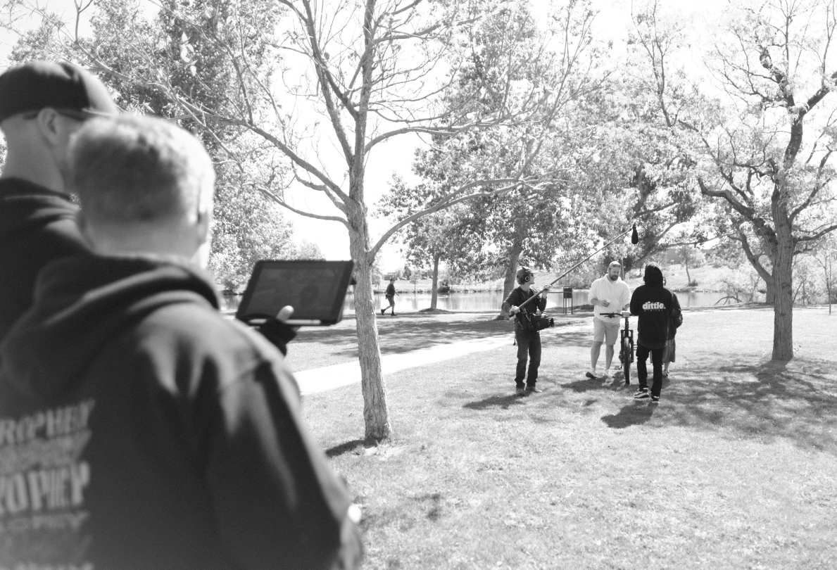 A series of black and white photos showing people walking and gathering in a park-like setting on a winter day.