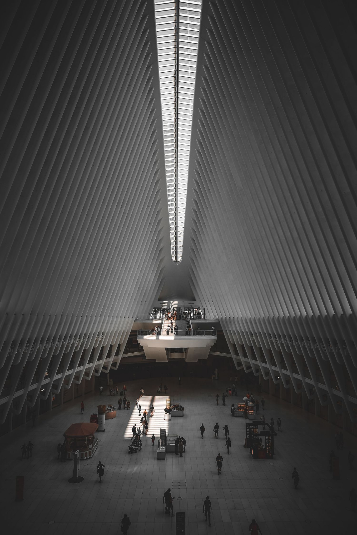 Interior view of the Oculus at the World Trade Center in New York City, showing its distinctive white ribbed architectural design.