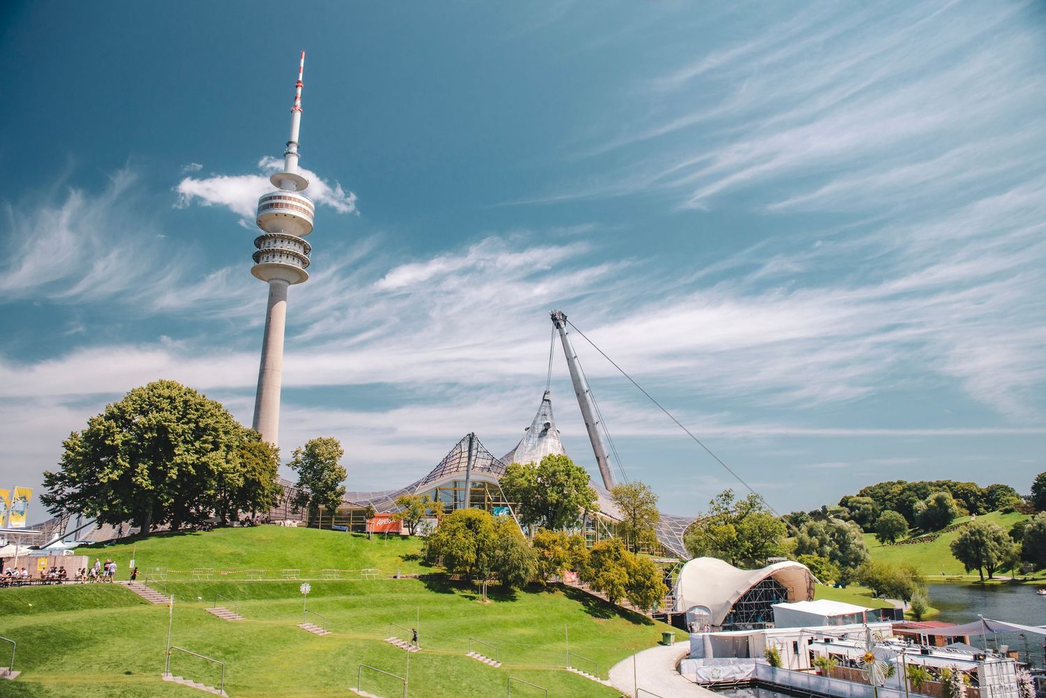 Olympiapark in Munich, Germany, featuring the prominent Olympiaturm tower and the iconic tent-like stadium roof.