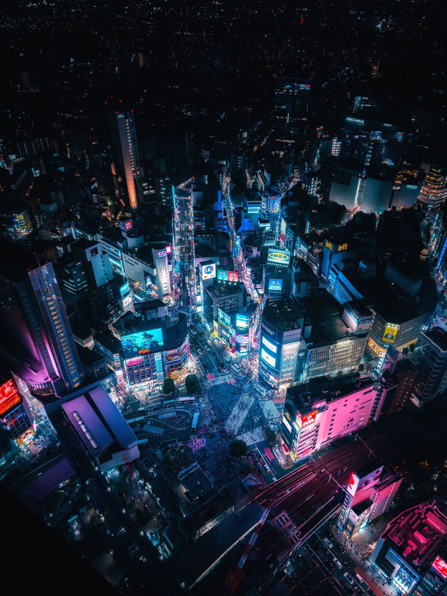 Aerial night view of the illuminated Shibuya Crossing in Tokyo, Japan, captured from the Shibuya Sky observation deck.