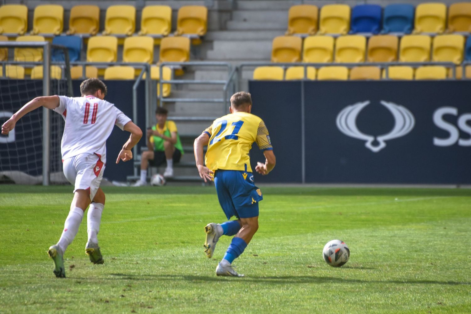Youth football players in action during an FC DAC 1904 match at the MOL Arena in Dunajská Streda, Slovakia.