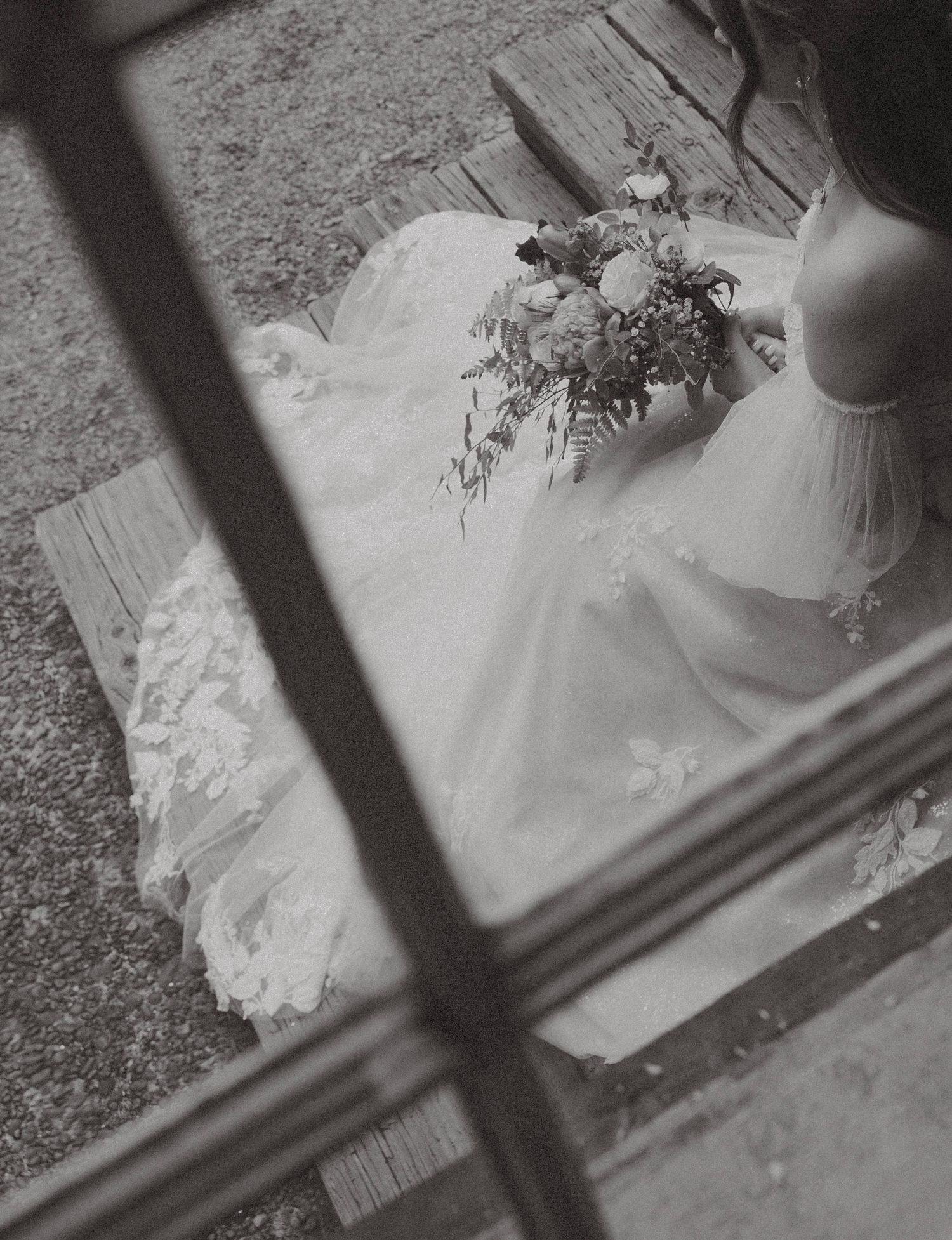 Candid editorial style wedding photography at Camp Lane Oregon featuring bride holding bouquet by window during forest micro-wedding