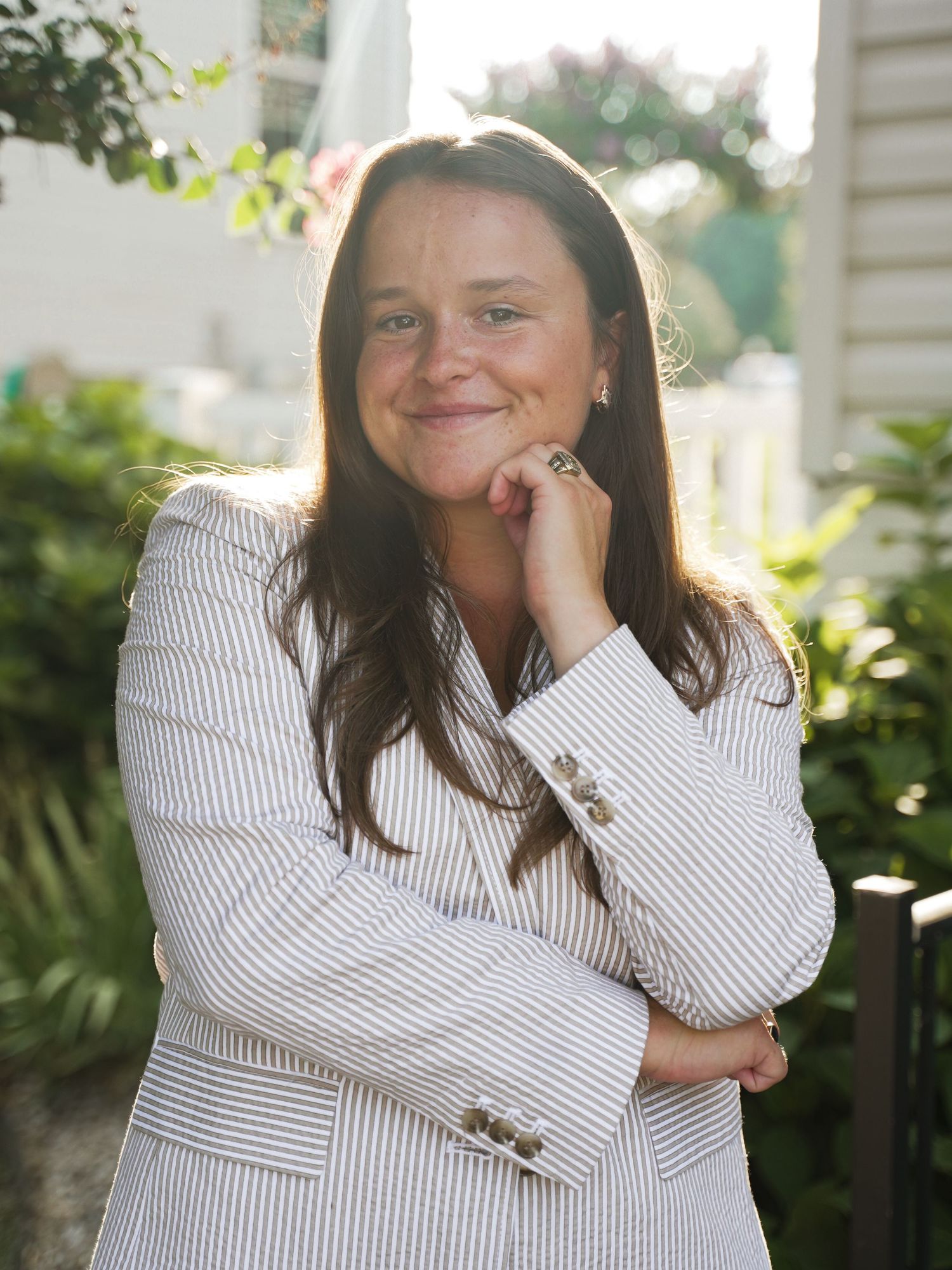Four candid outdoor portraits showing serene expressions and a white striped button-down in natural sunlight.