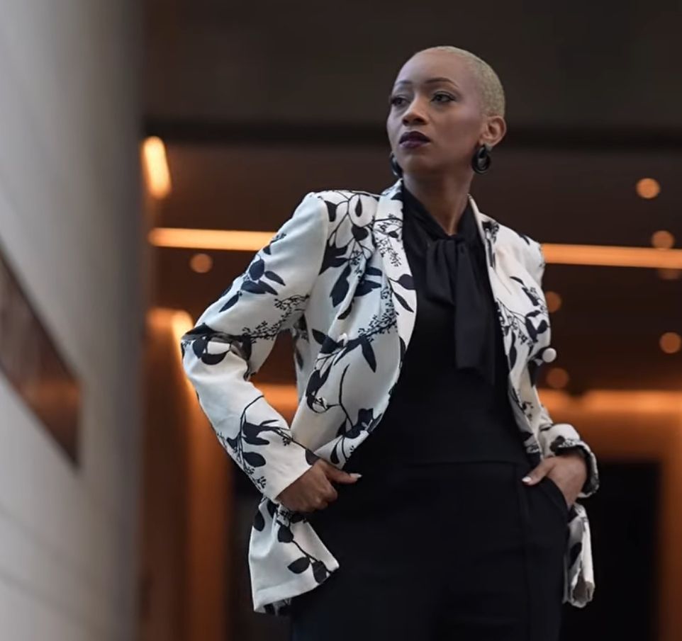 Bold fashion statement in black and white floral print blazer with minimalist styling.