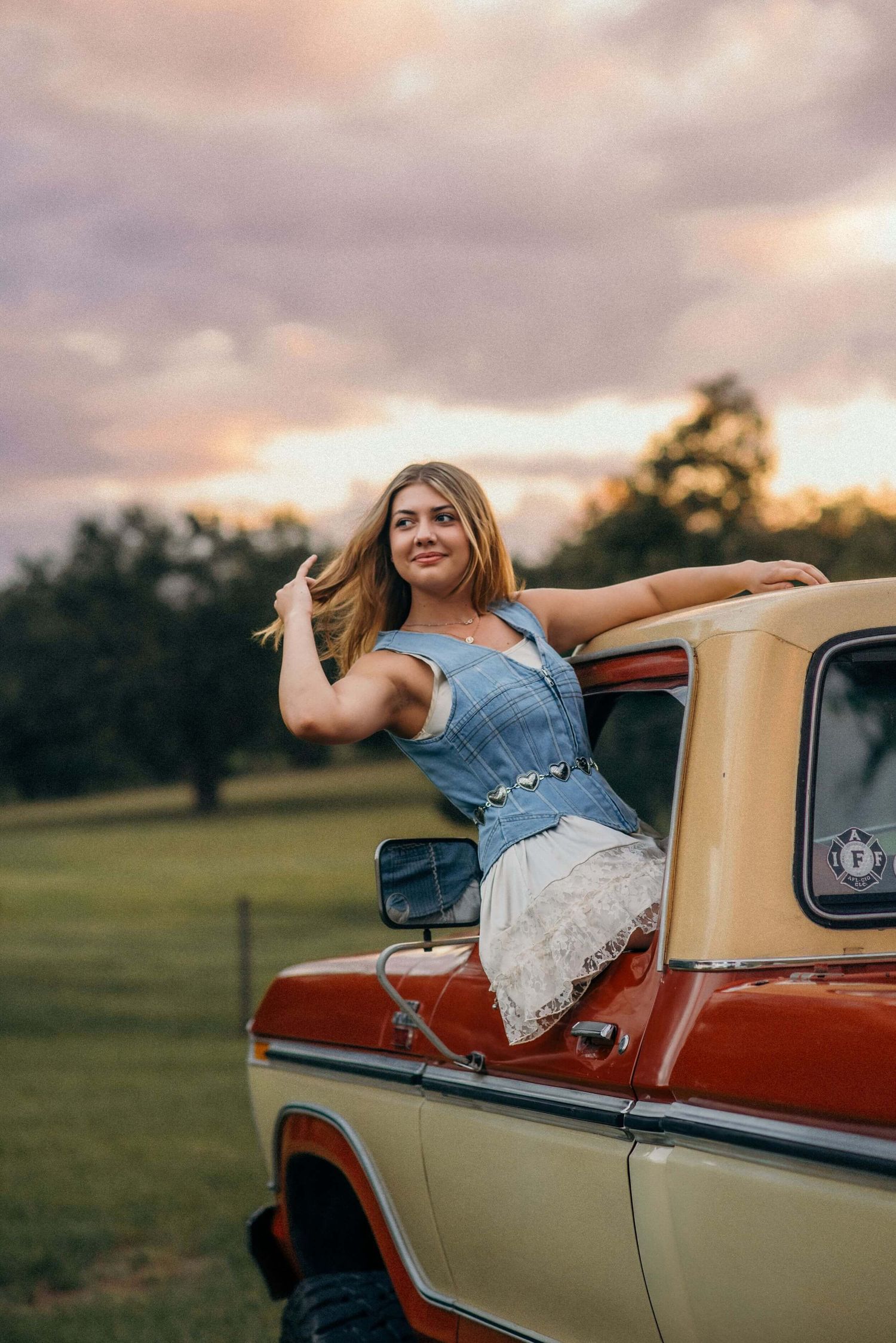 Vintage two-tone pickup truck captured during a golden sunset photoshoot.