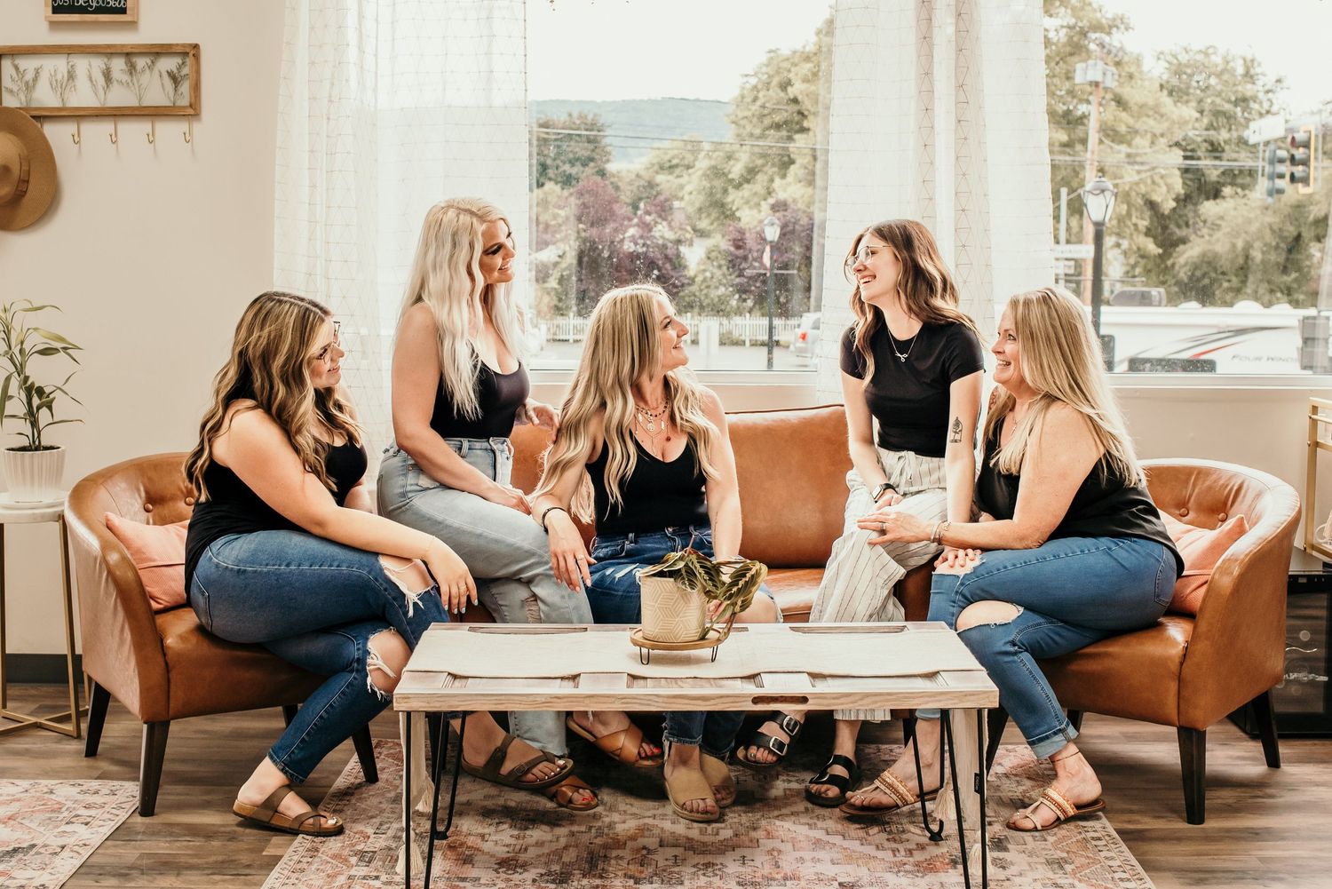 Casual group gathering in modern studio space with comfortable seating and natural light.