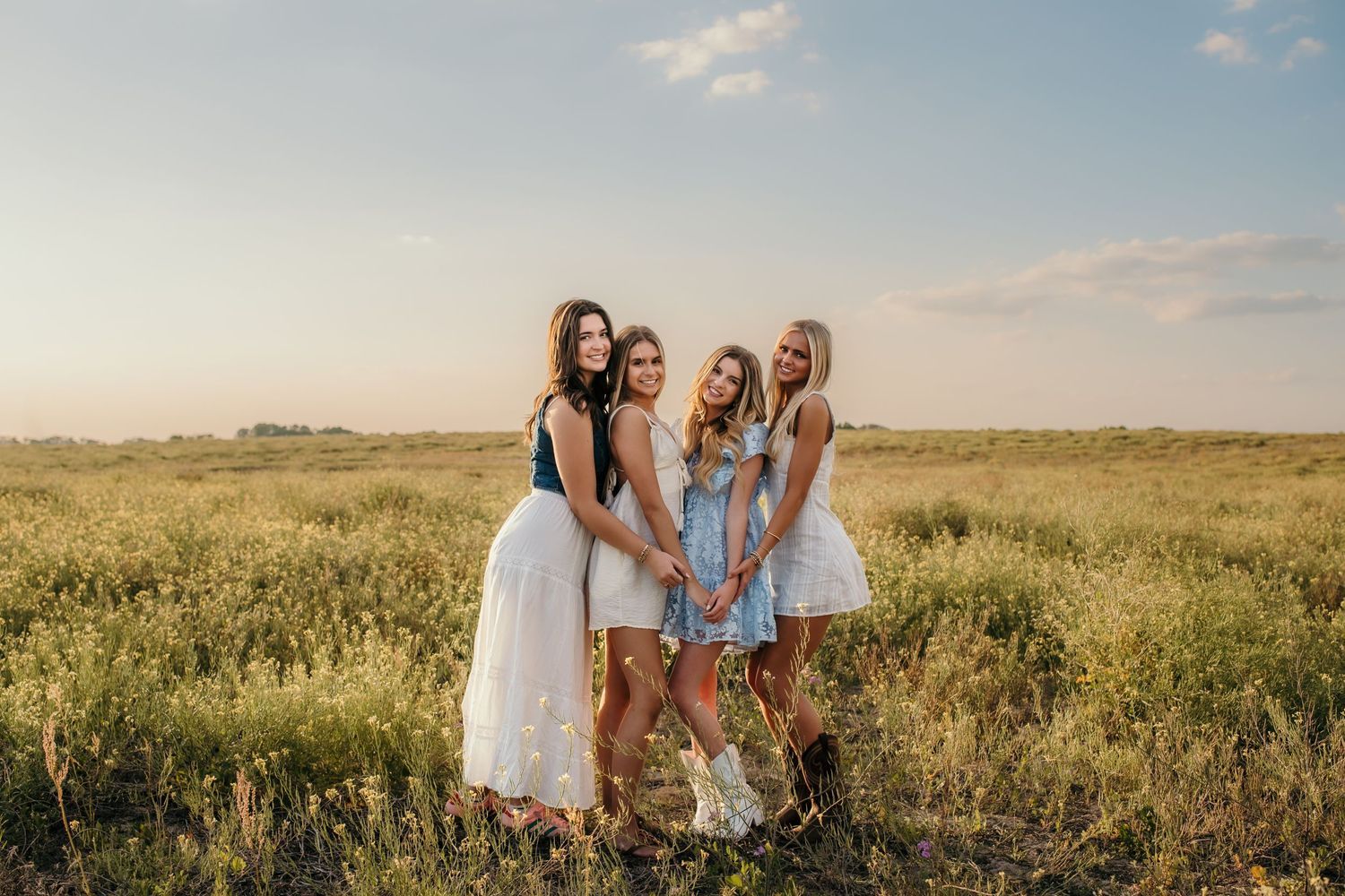 Group photo session in natural field setting during golden hour.