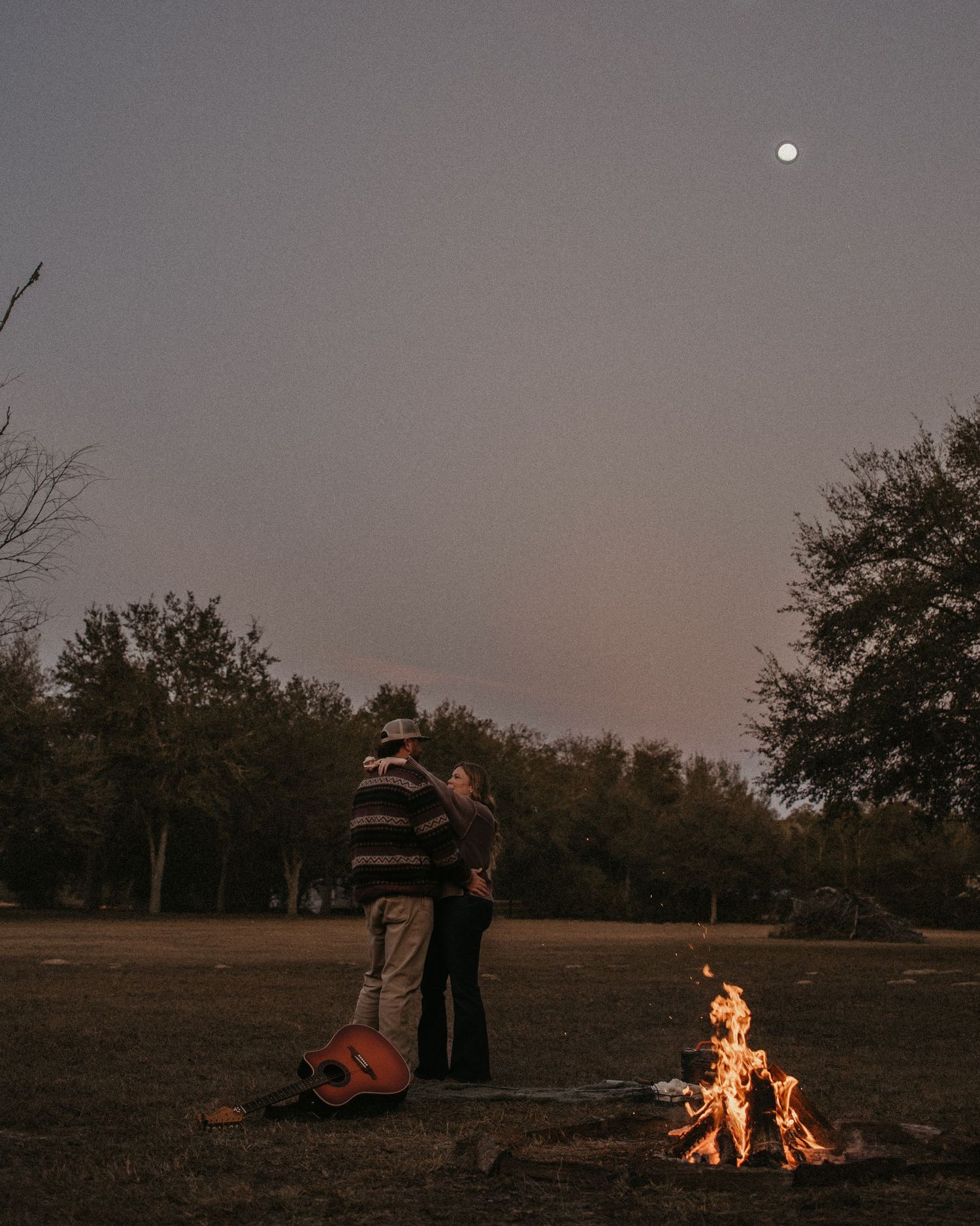 A series of moody twilight landscape photos showing a campfire and moon against a darkening sky.