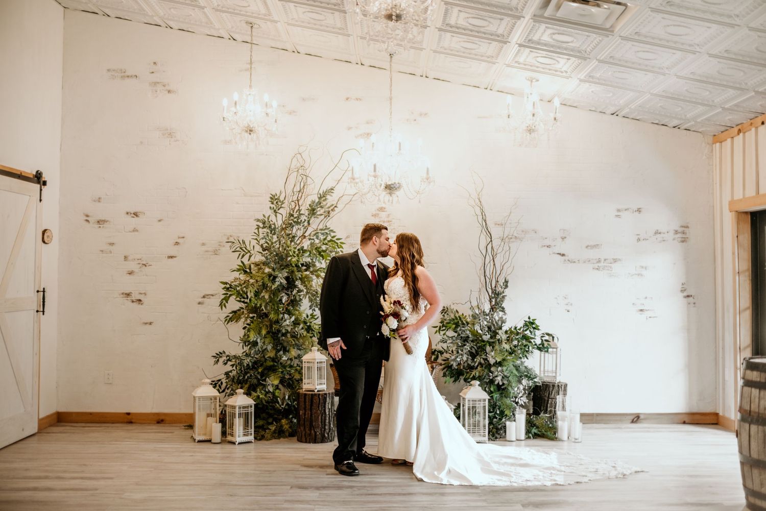 White vintage-style room with high ceilings and minimalist wedding decor.