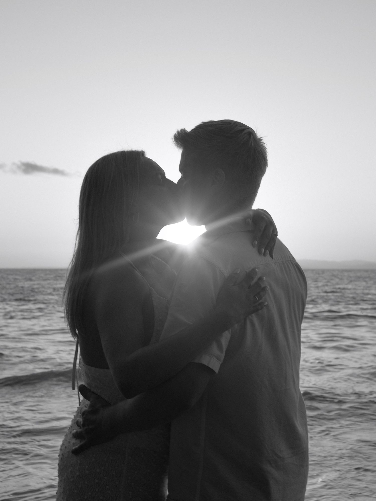 Photo by Bendito Recuerdo in Costa Rica, couple kissing during sunset at a Pacific coast beach in Costa Rica it may be in black and white