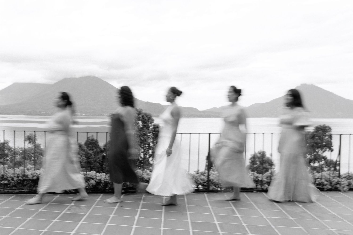 Photo by Bendito Recuerdo in Lake Atitlán, five women walking in a straight line one after the other it may be in black and white