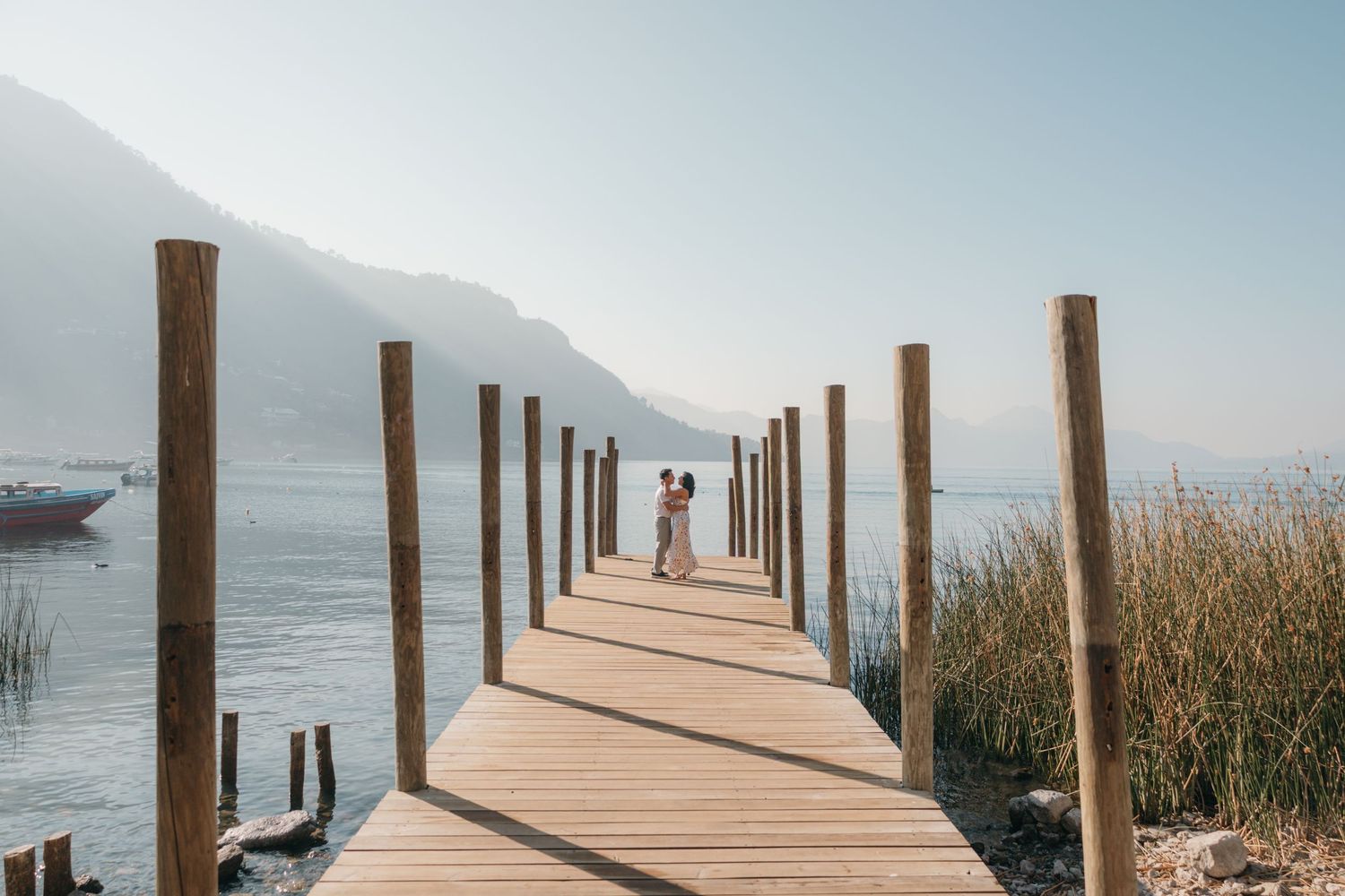 Newly engaged couple dancing on a dock in Lake Atitlán