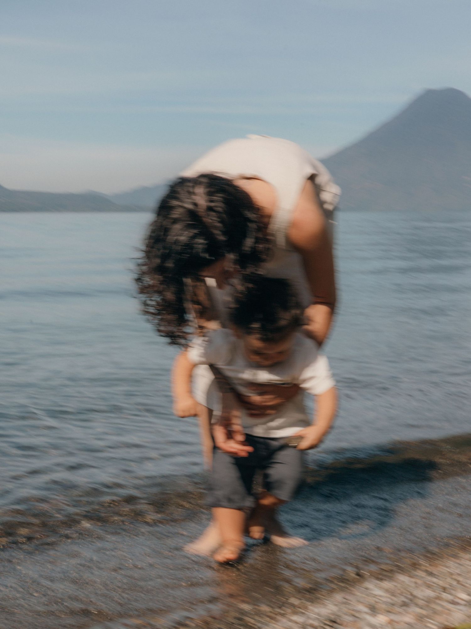 Photo by Bendito Recuerdo in Lake Atitlán, motion blur take of mother and son photoshoot for his first birthday.