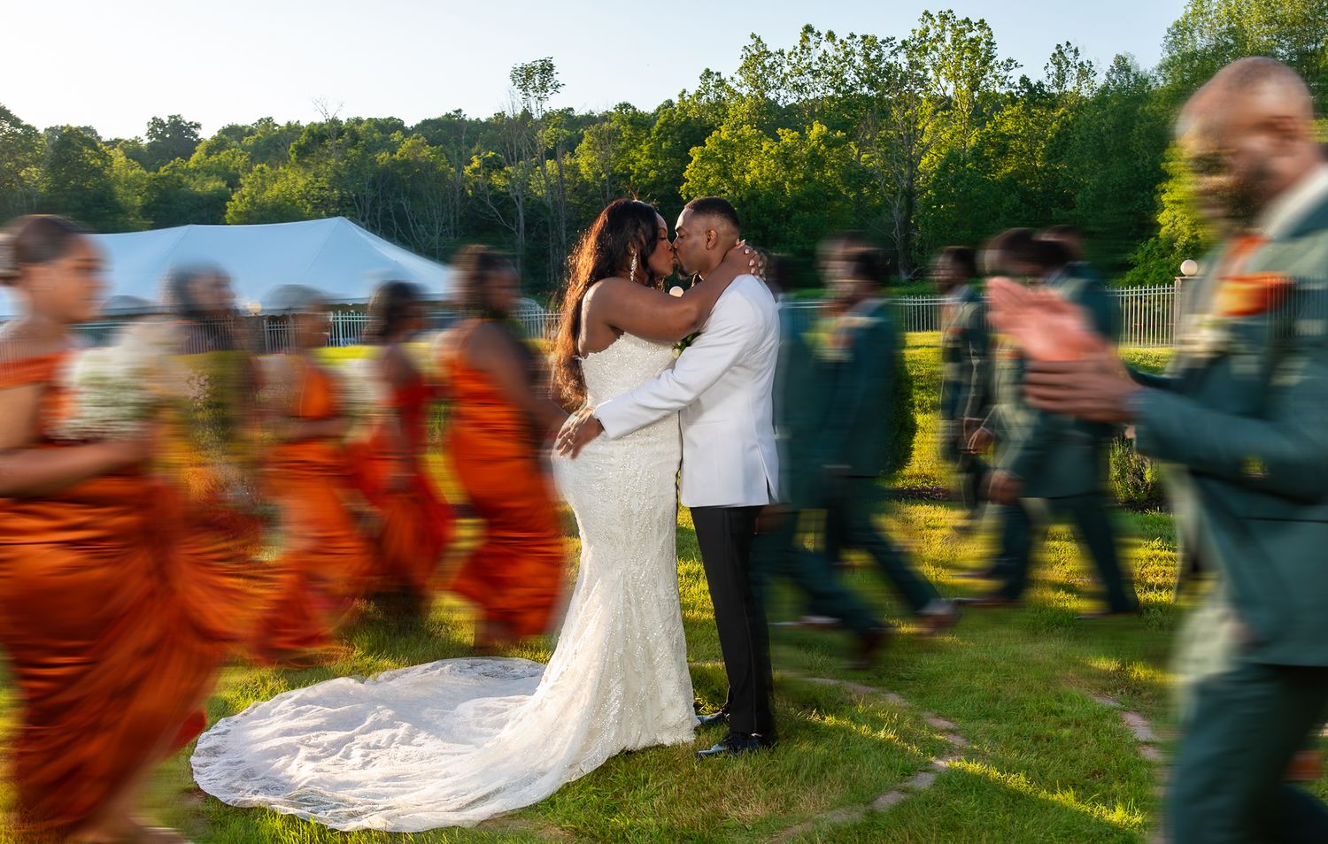 iconic dramatic kissing scene with bridal party running around