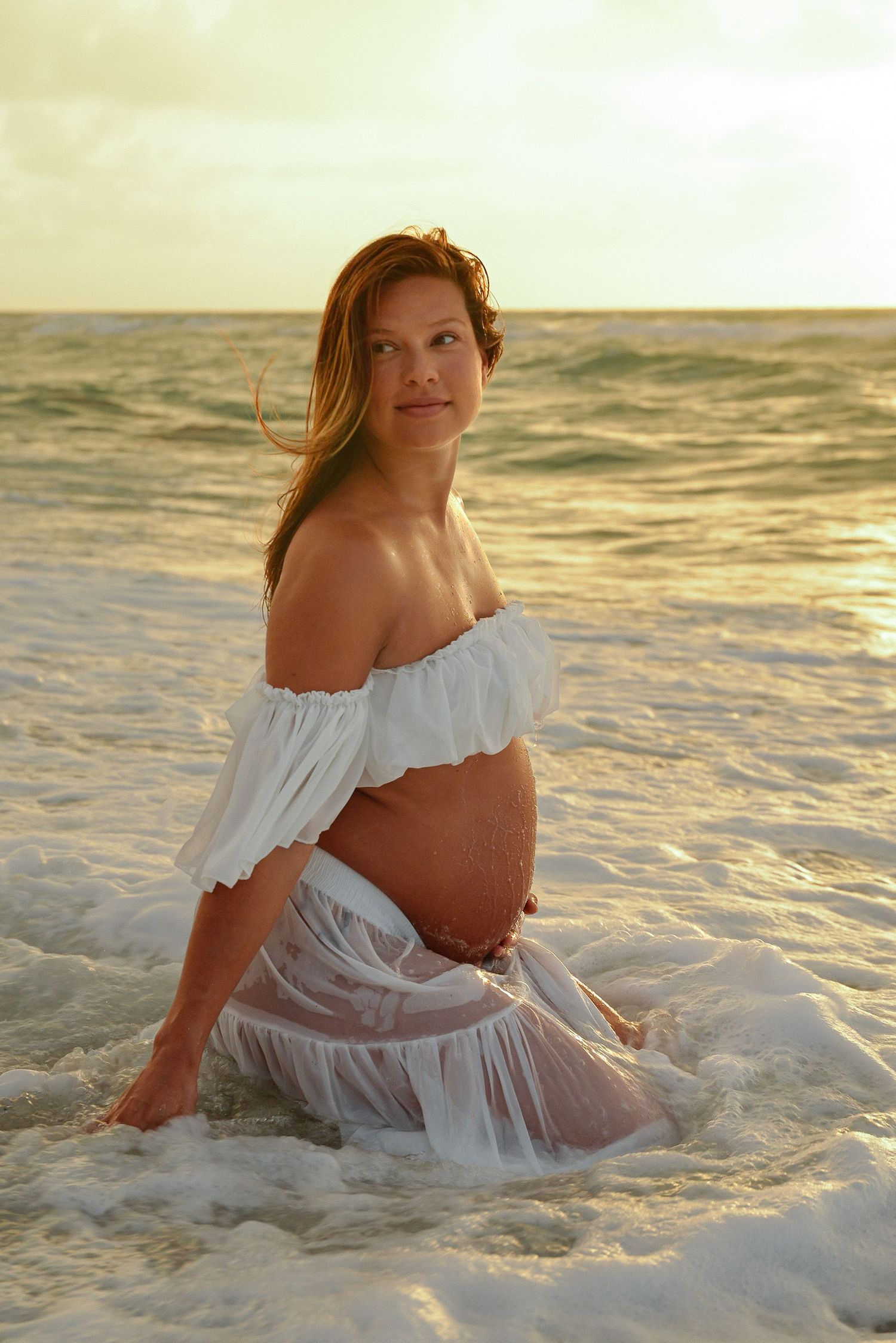 mother to be sunrise maternity session looking away