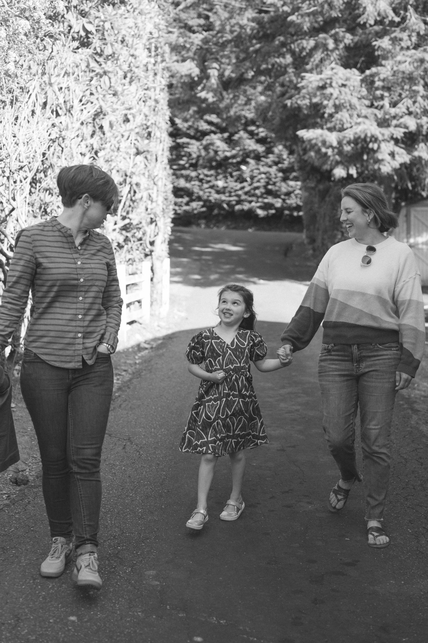 A group walking together on a path in black and white photography.