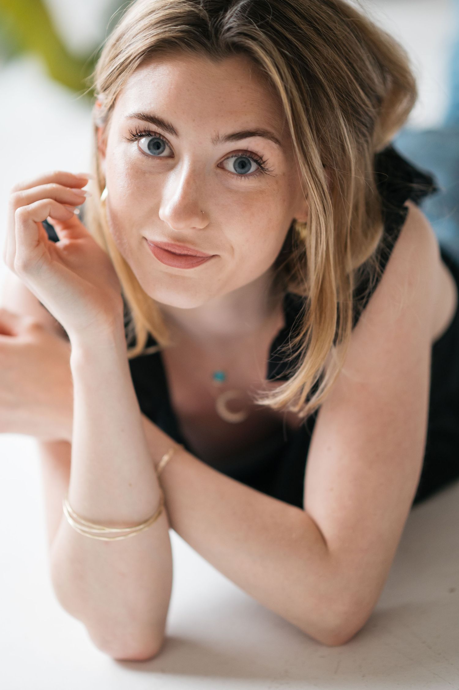 Close-up portrait series showing expressive poses with hands framing face.