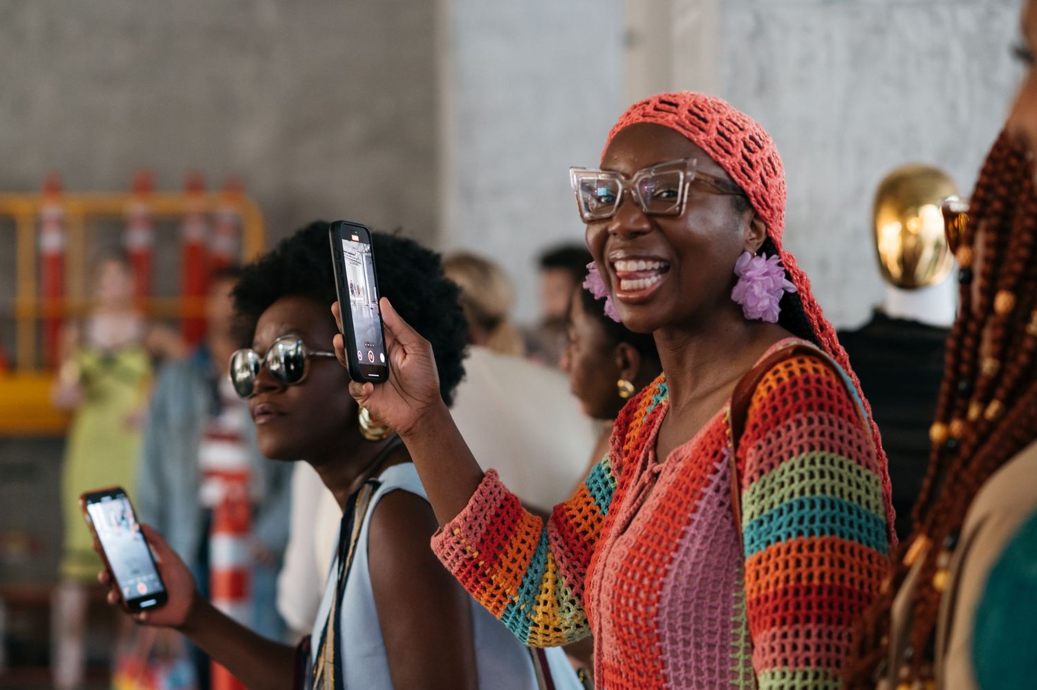Group wearing colorful knit accessories gather at social event.