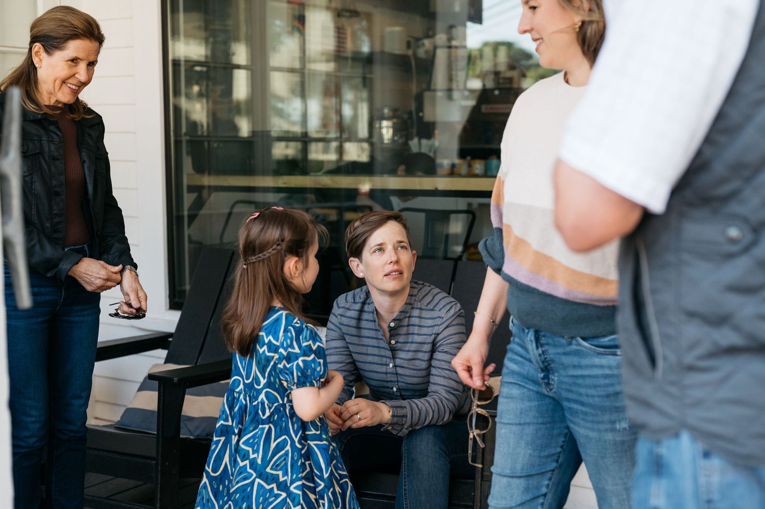 A group engaged in lively conversation on an outdoor patio.