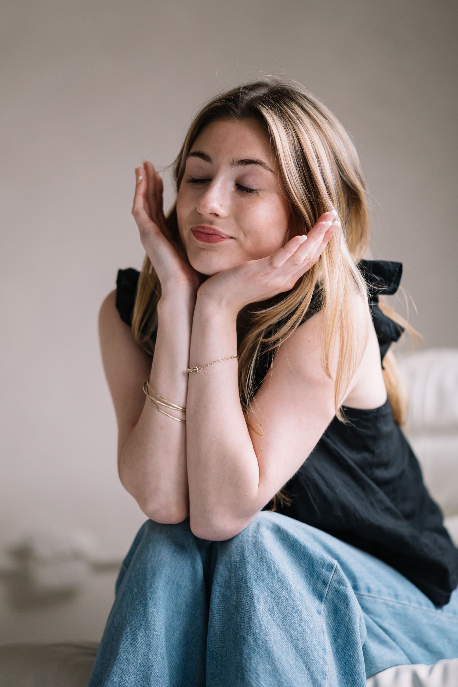 Person in casual attire lying down and making expressive poses.