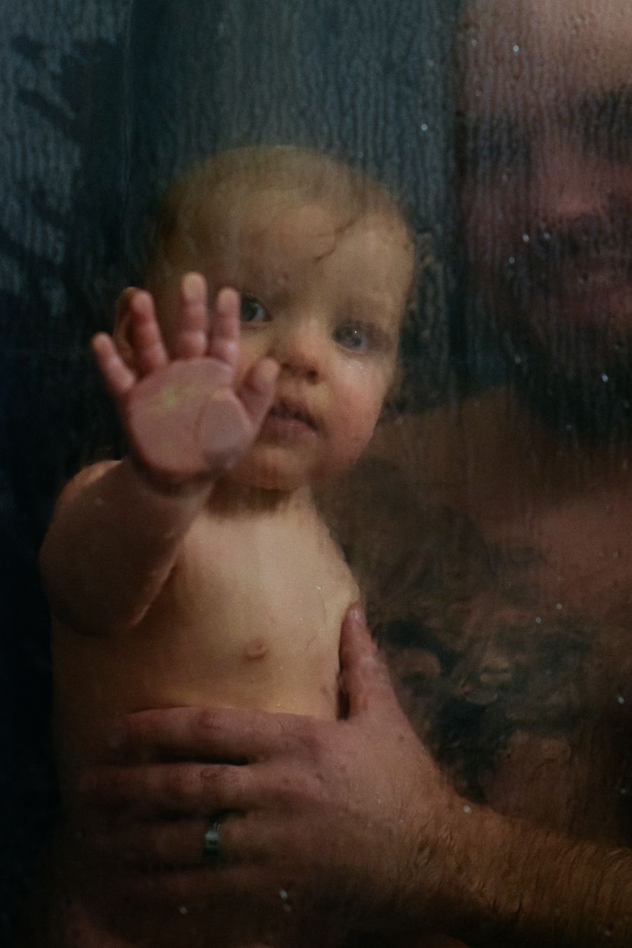 A series of underwater-style photos showing a baby's movements through glass.