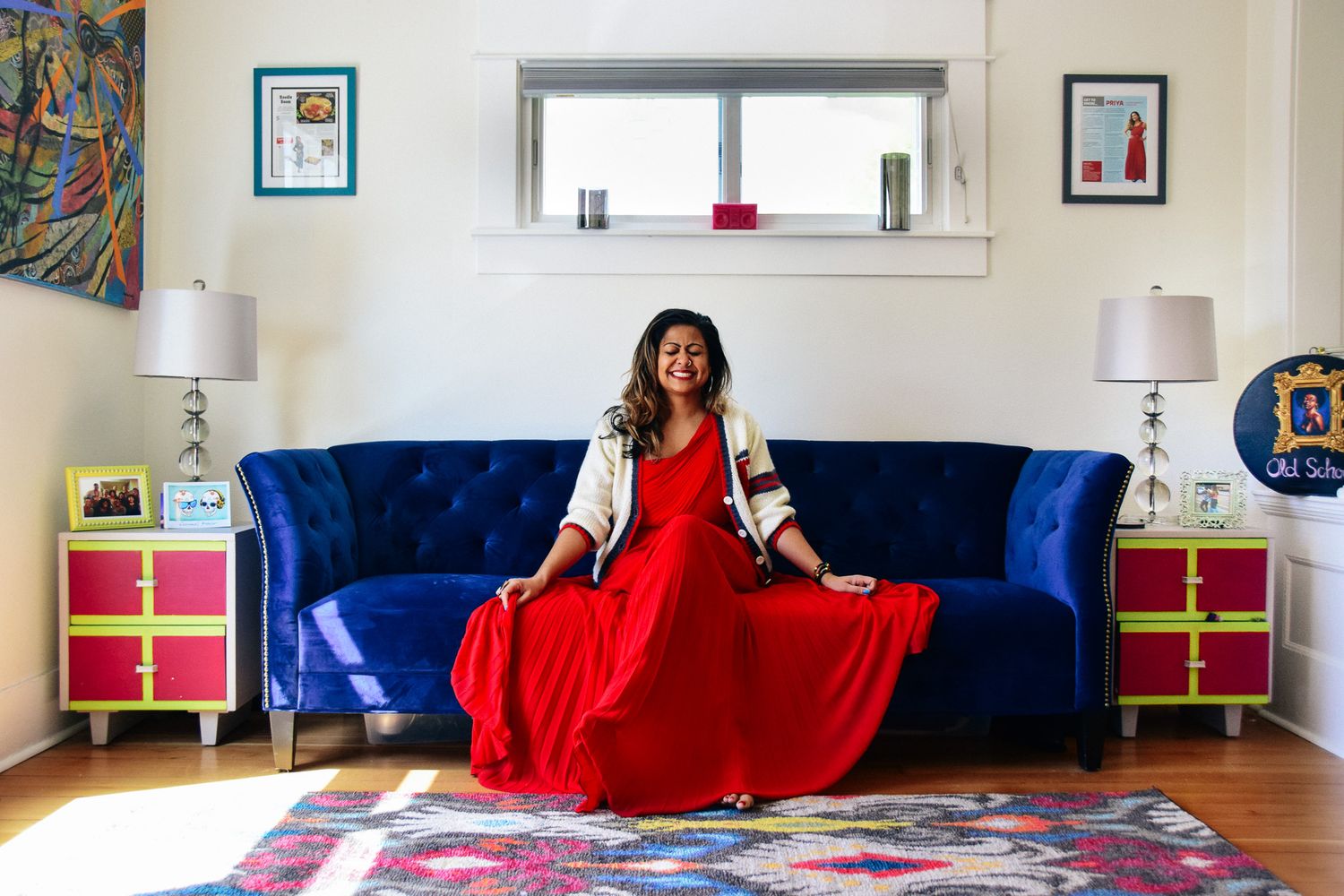 Interior lifestyle scene with red accents and blue furniture in a modern living room.