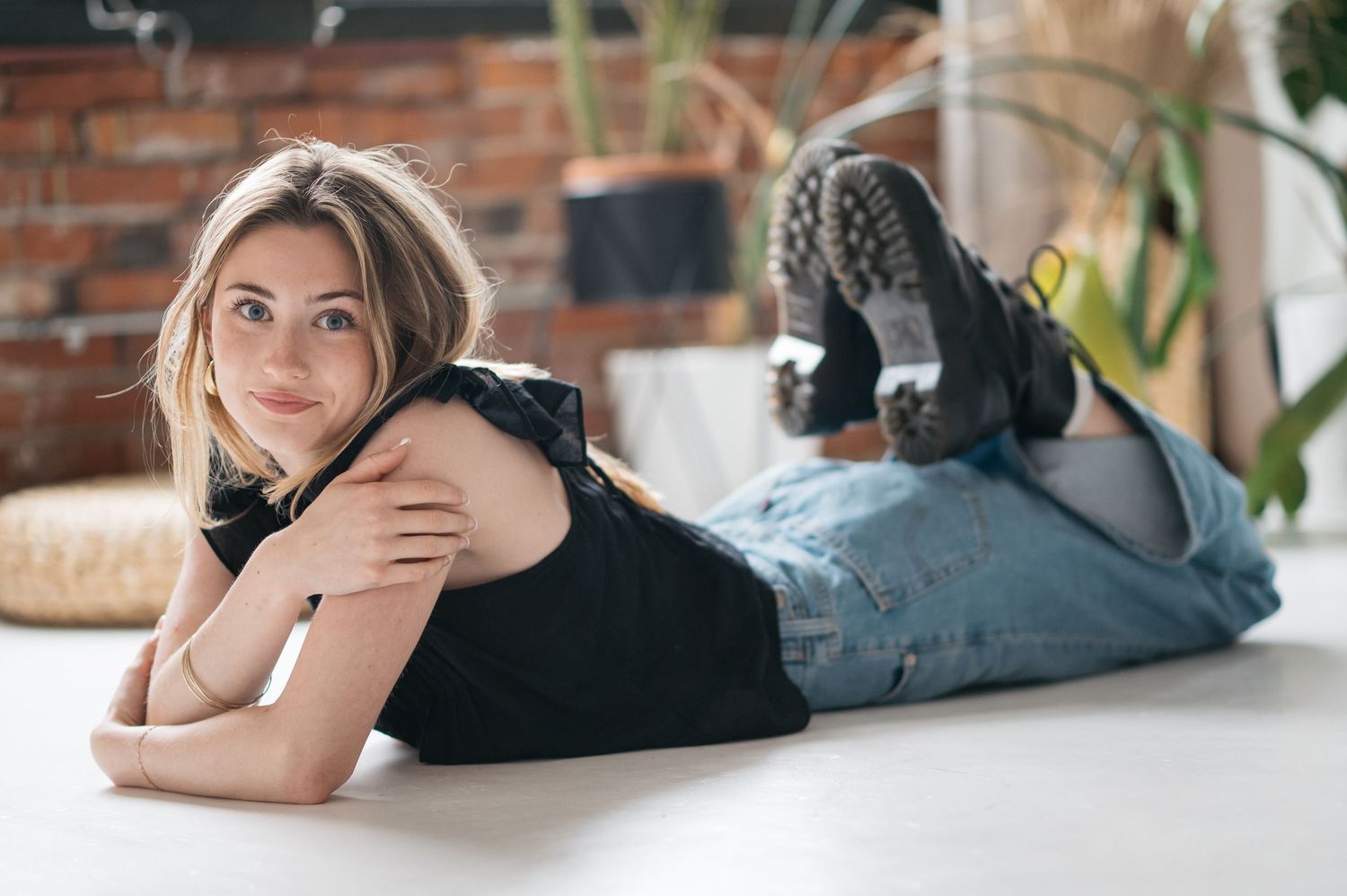 Person in black top lying on floor making various casual poses.