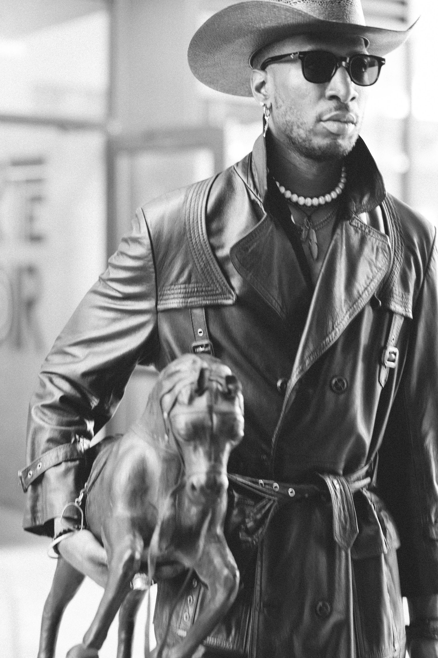 People in leather jackets walking together in black and white photograph.